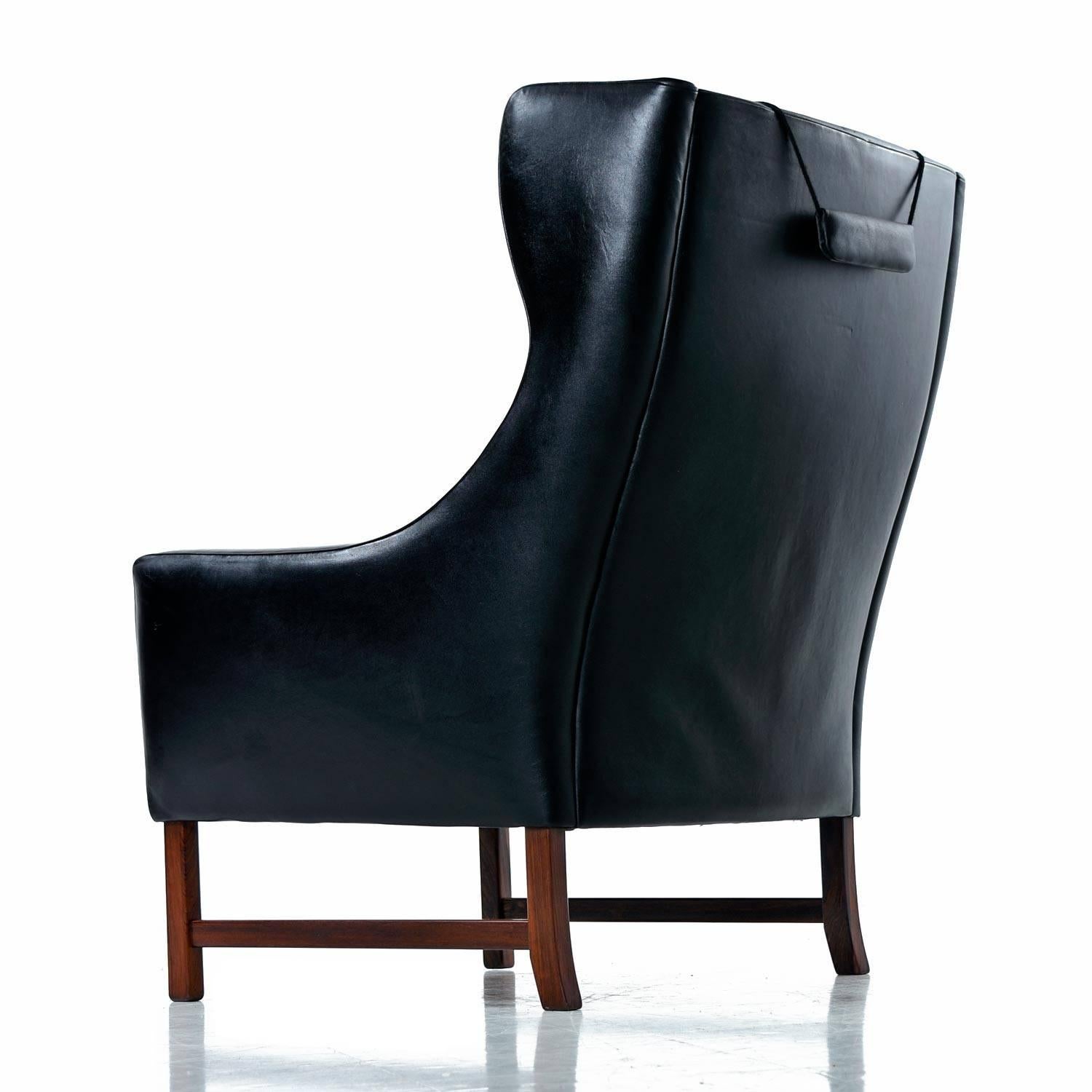 Scandinavian Fredrik Kayser Black Leather and Rosewood Wingback Lounge Chair and Ottoman