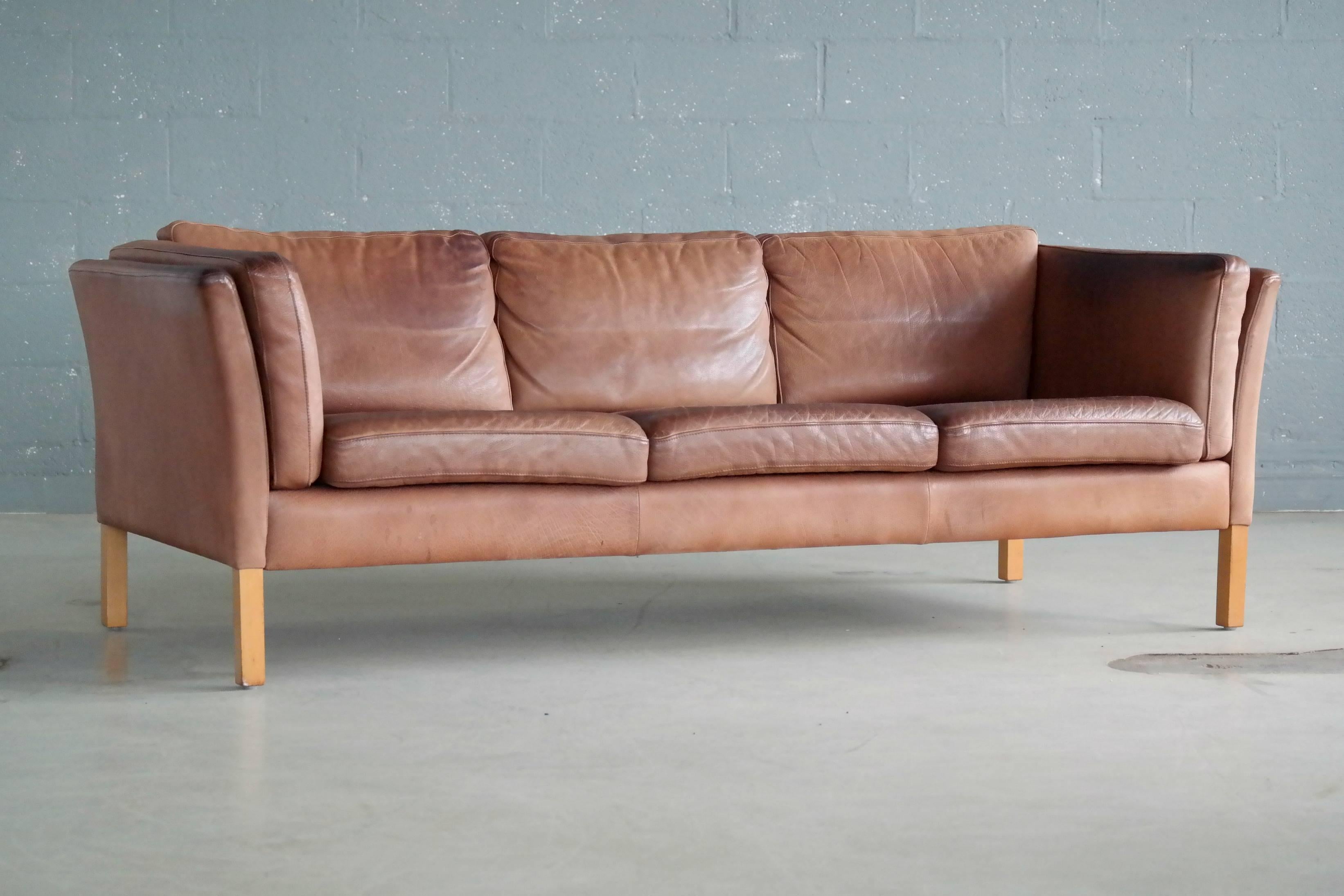 Highest quality craftsmanship Borge Mogensen style sofa in light cognac colored buffalo leather by Stouby Mobler. Thick supple buffalo leather showing great grain - some sun fading of the color and just the perfect amount of patina and wear, scuffs