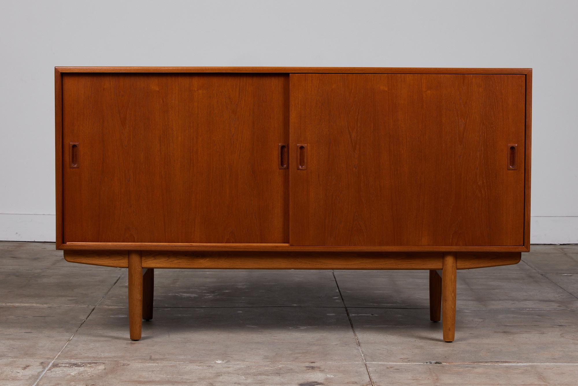 Børge Mogensen teak and oak cabinet for Soborg Mobler, Denmark, c.1950s. This cabinet features four interior drawers with two adjustable shelves.

Dimensions: 59