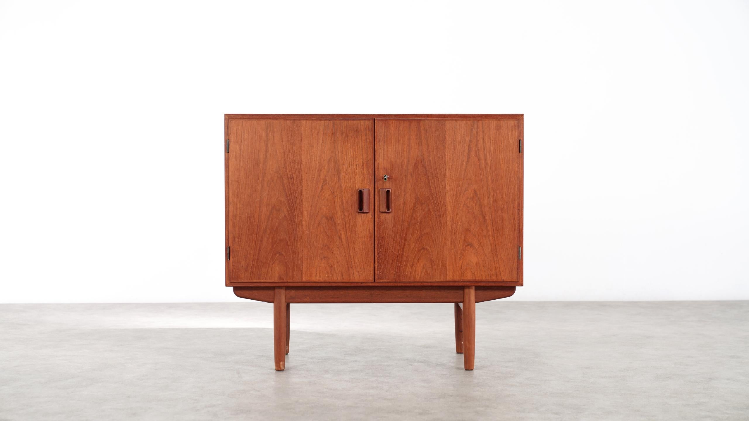 Teak and oak sideboard, designed by Danish designer Børge Mogensen for Søborg Møbelfabrik, circa 1950.
 
Absolutely charming small credenza, fitting kind of everywhere!
Front with two doors and sophisticated handles in massive teak wood, inside