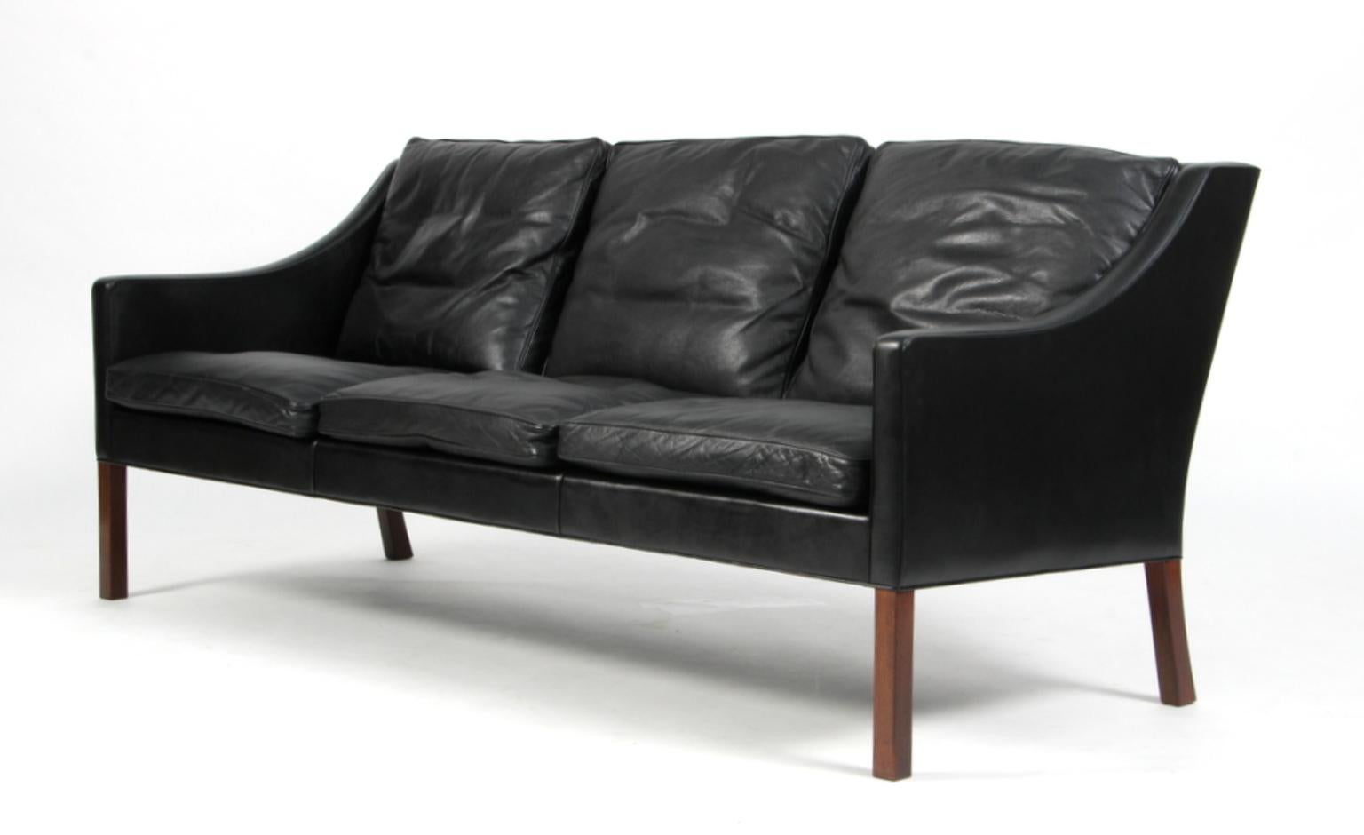 Børge Mogensen three-seat sofa original upholstered in lightly patinated black leather.

Legs of mahogany.

Model 2209, made by Fredericia Furniture.