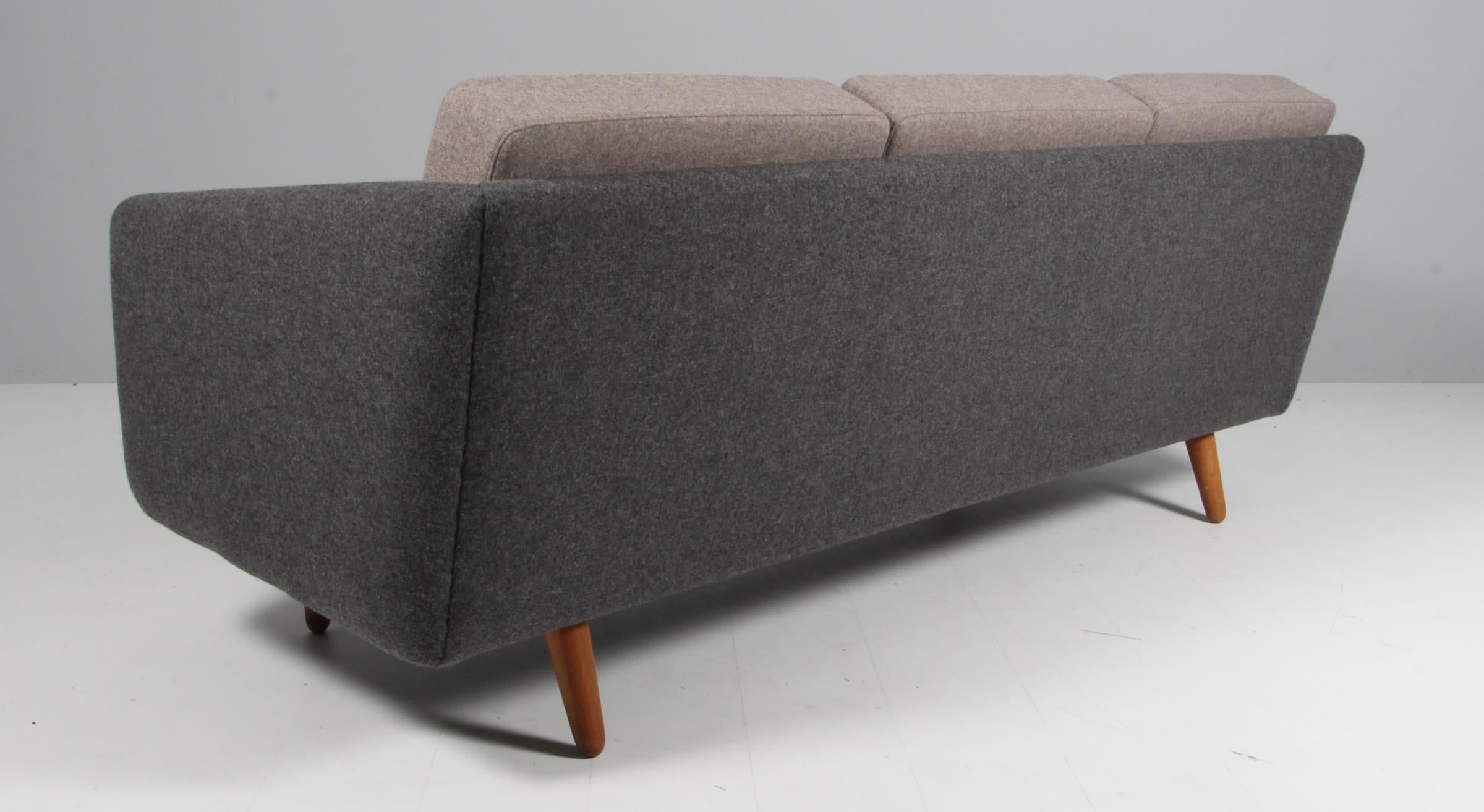 Børge Mogensen three-seat sofa, new upholstered with light and dark grey 100 % New Zealand wool.

Legs of oak.

Model 201, made by Fredericia Furniture.

This is the old model 201 which was the first sofa that Børge Mogensen designed. The model have