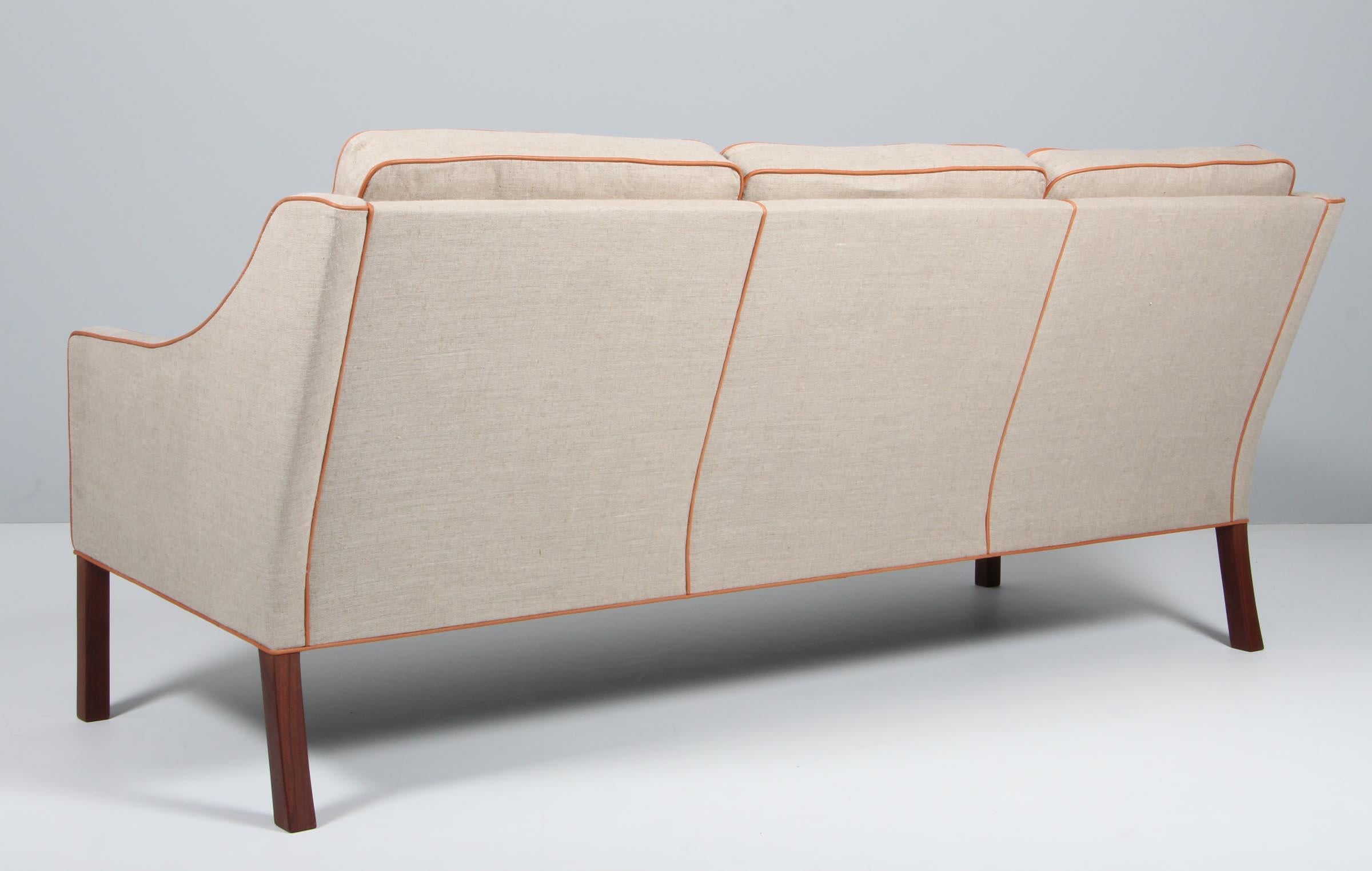 Børge Mogensen three-seat sofa new upholstered with canvas and tan aniline leather

Legs of mahogany.

Model 2209, made by Fredericia furniture.