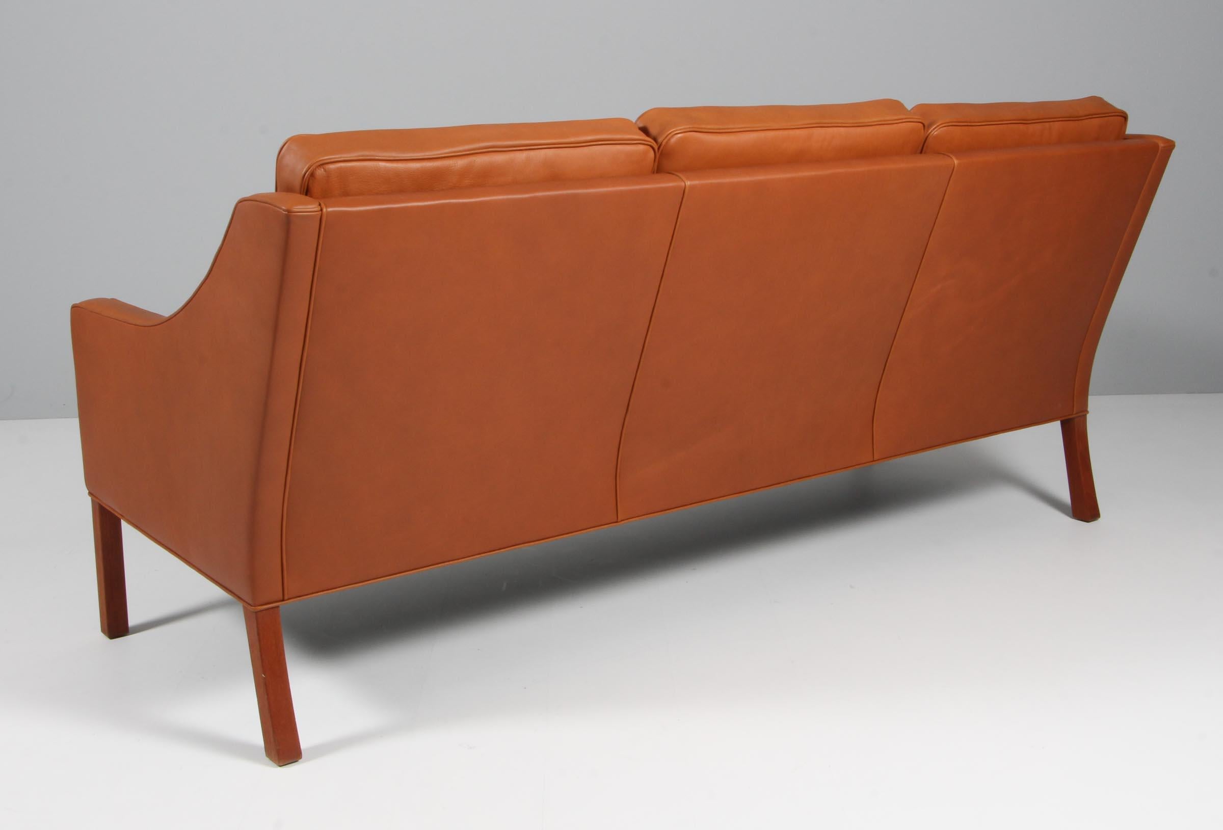 Børge Mogensen three-seat sofa new upholstery with walnut elegance aniline leather.

Legs of teak.

Model 2209, made by Fredericia furniture.
