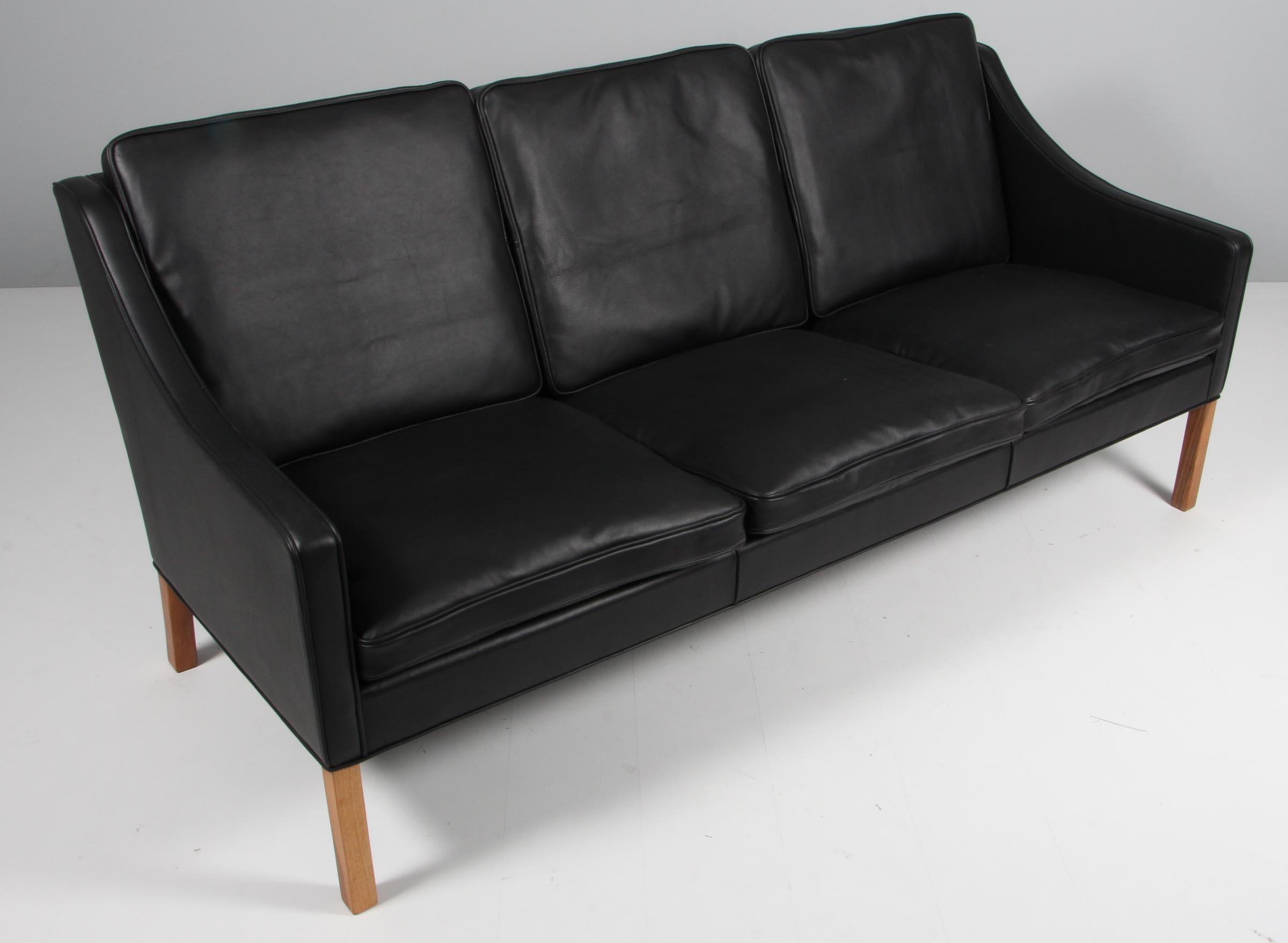 Børge Mogensen three-seat sofa new upholstery with black elegance aniline leather.

Legs of teak.

Model 2209, made by Fredericia furniture.