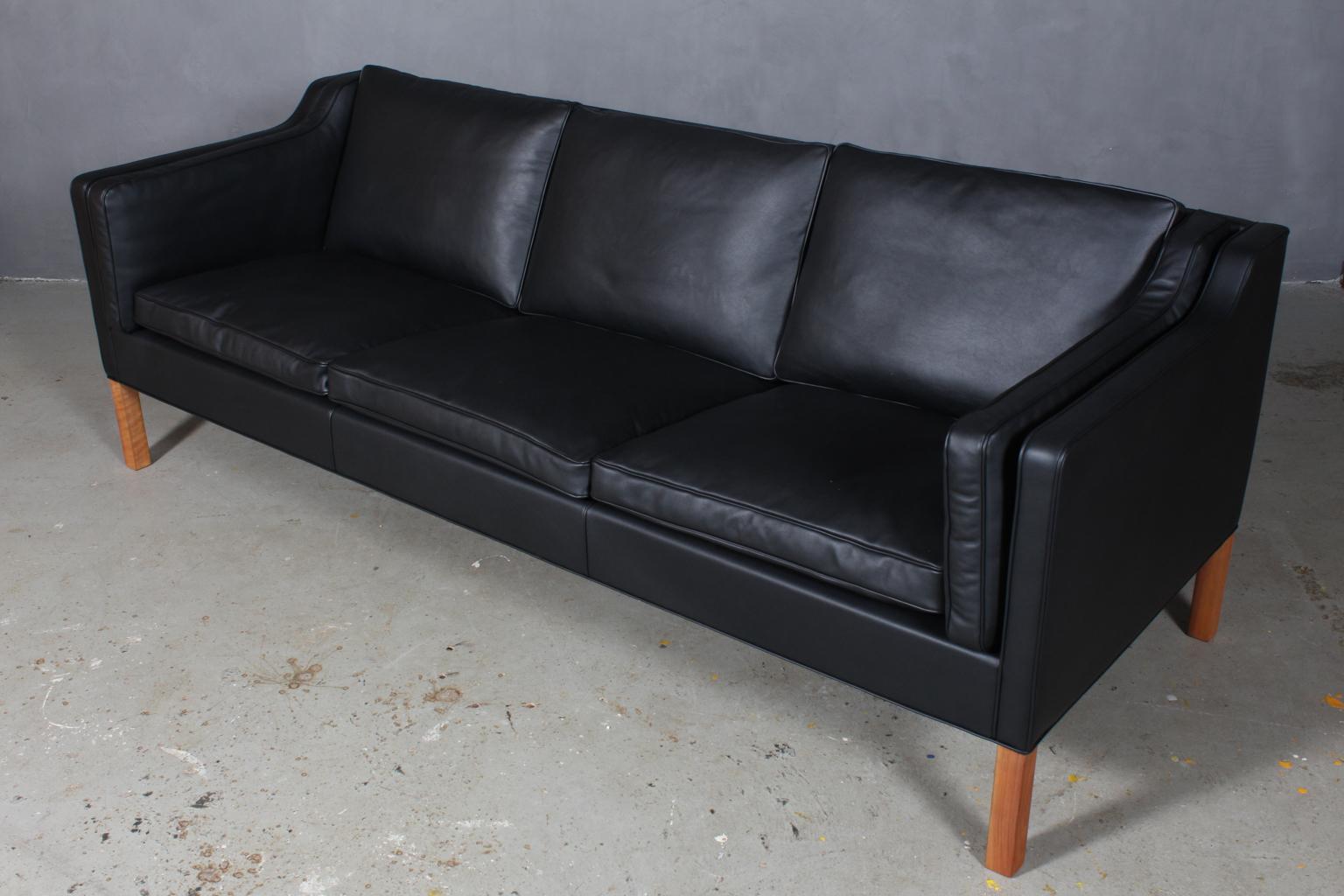 Børge Mogensen three-seat sofa new upholstered with black elegance aniline leather.

Legs of mahogany.

Model 2213, made by Fredericia Furniture.