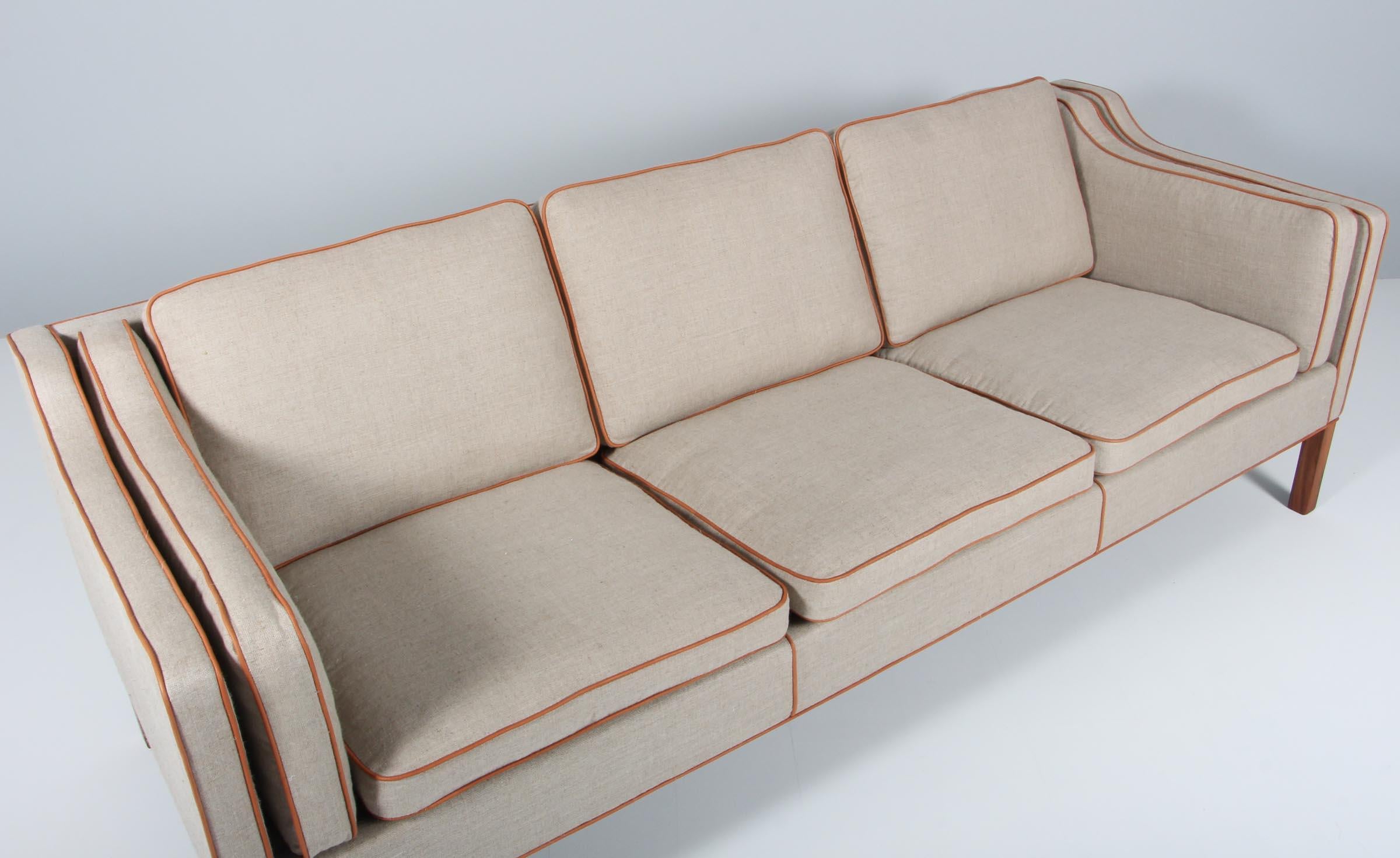 Børge Mogensen three-seat sofa new upholstered with cognac aniline leather and canvas.

Legs of teak.

Model 2213, made by Fredericia Furniture.