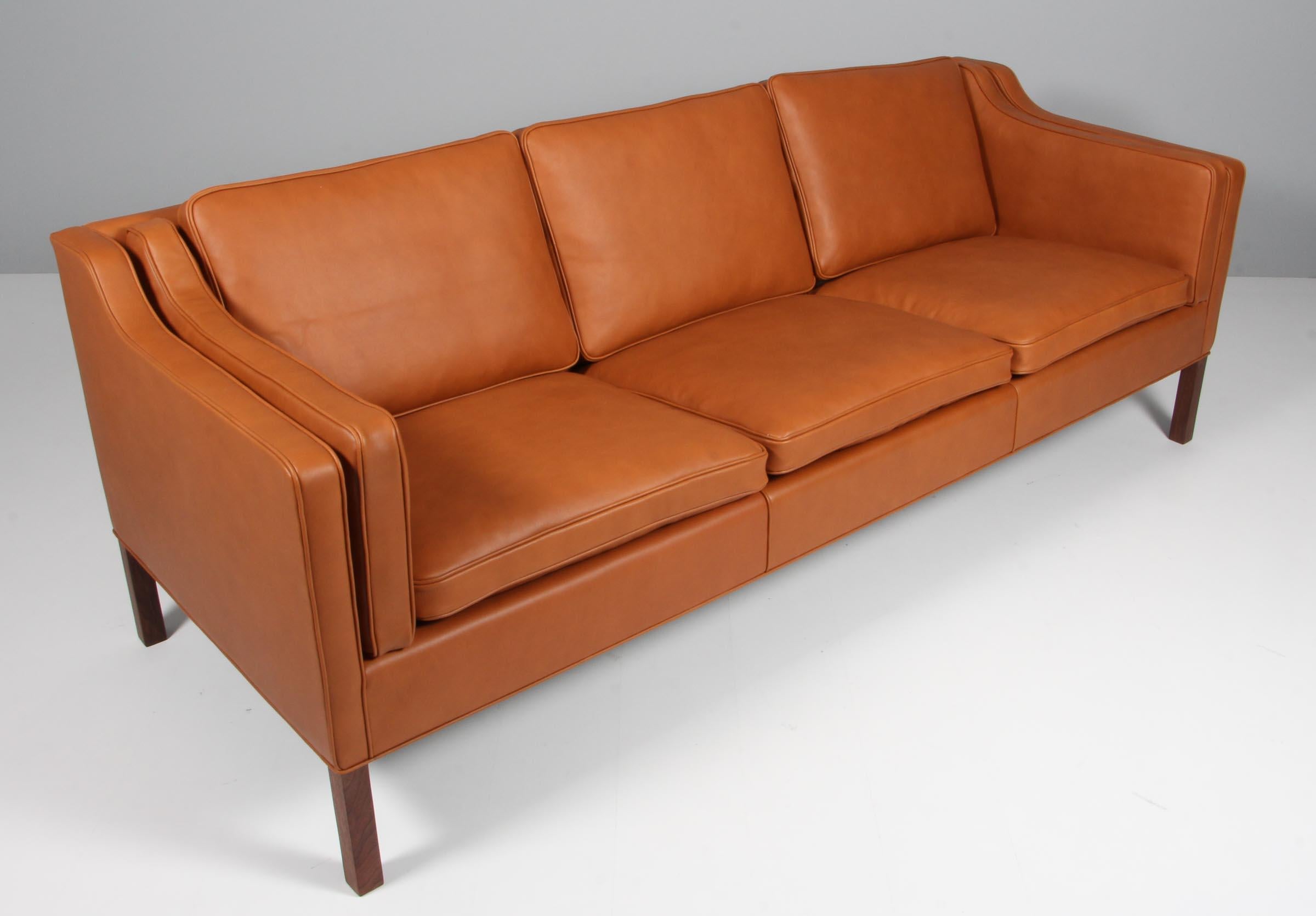 Børge Mogensen three-seat sofa new upholstered with walnut elegance aniline leather.

Legs of teak.

Model 2213, made by Fredericia Furniture.