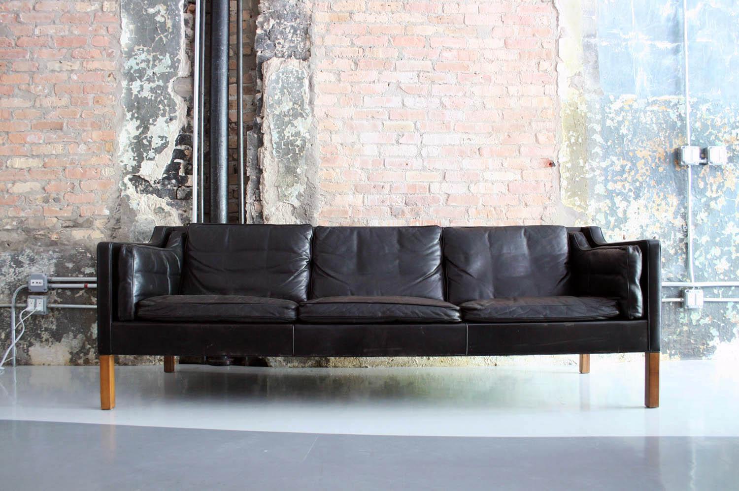 A beautiful vintage design in original black leather. Down filled cushions and sleek lines. Iconic Danish craftsmanship and design at its finest.