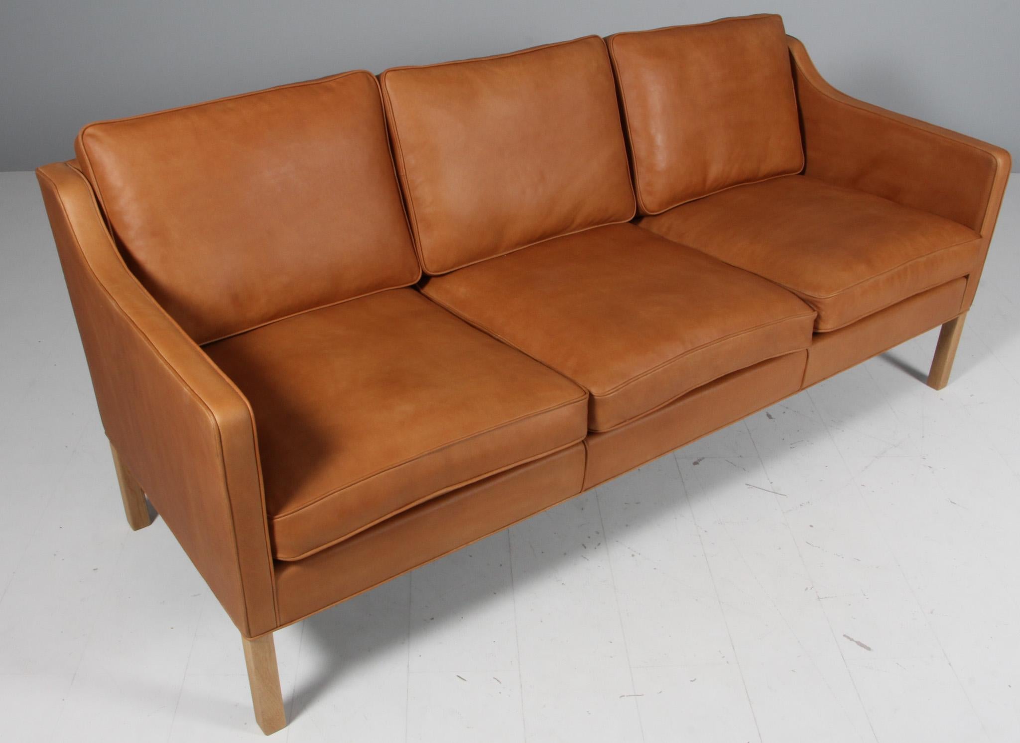 Børge Mogensen three-seat sofa new upholstered with vintage full grain aniline leather.

Legs of soap treated oak.

Model 2323, made by Fredericia Furniture.