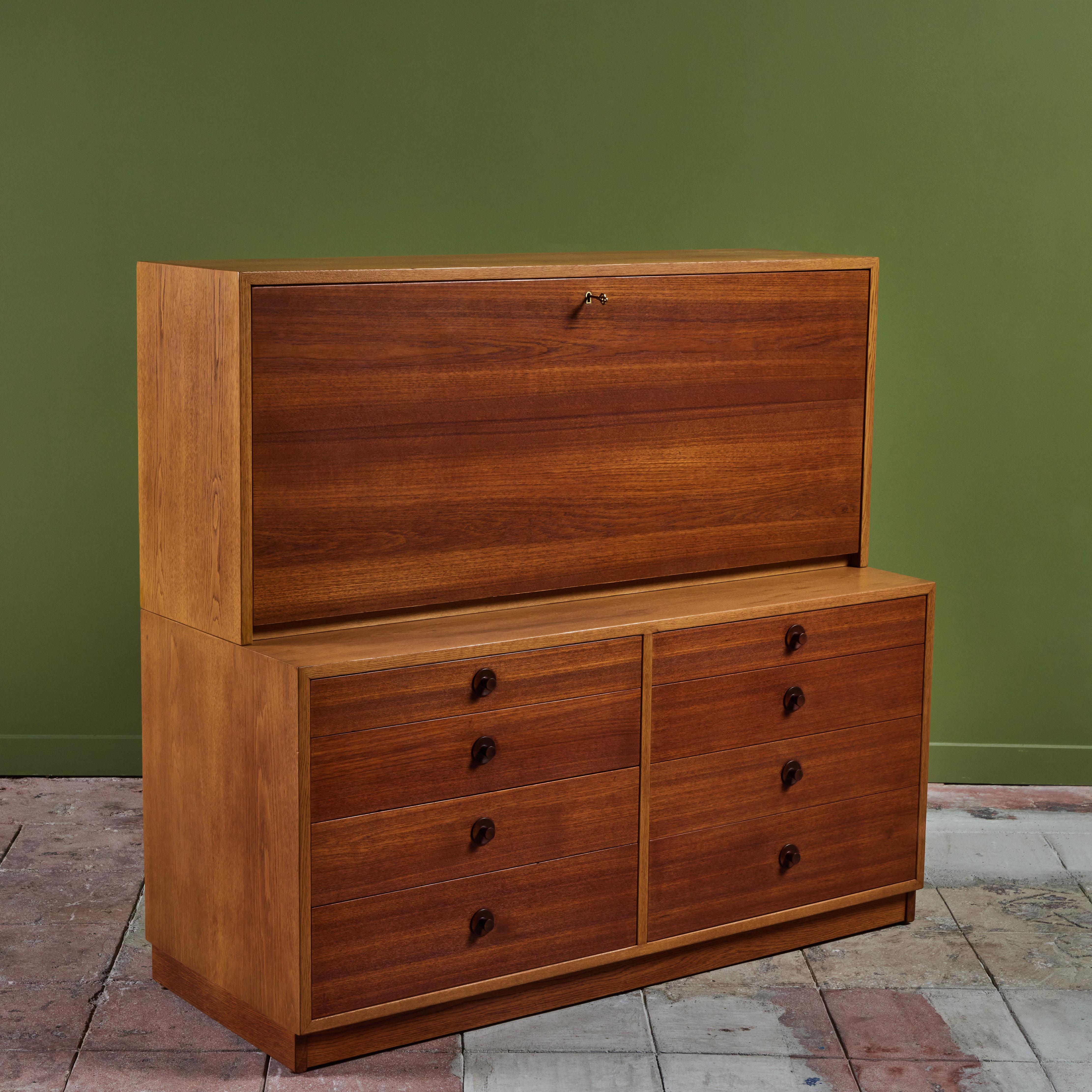 Oak and teak storage unit and desk by Børge Mogensen for Karl Andersson and Sons c.1960s, Sweden. This two piece storage cabinet has eight drawers along the lower cabinet and a drop front upper cabinet with key. The interior of the top portion has