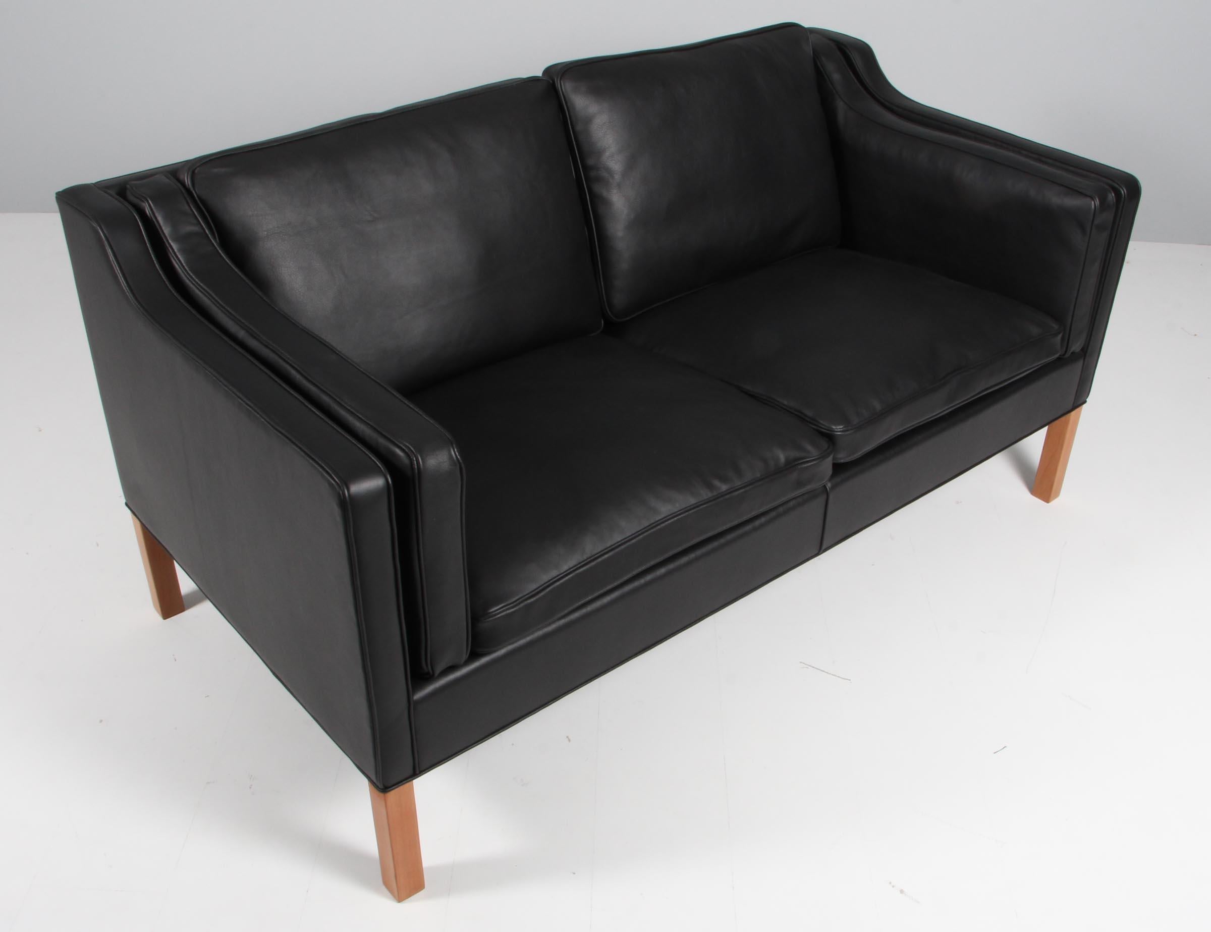 Børge Mogensen two-seat sofa new upholstered with walnut elegance aniline leather.

Legs of mahogany.

Model 2212, made by Fredericia Furniture.