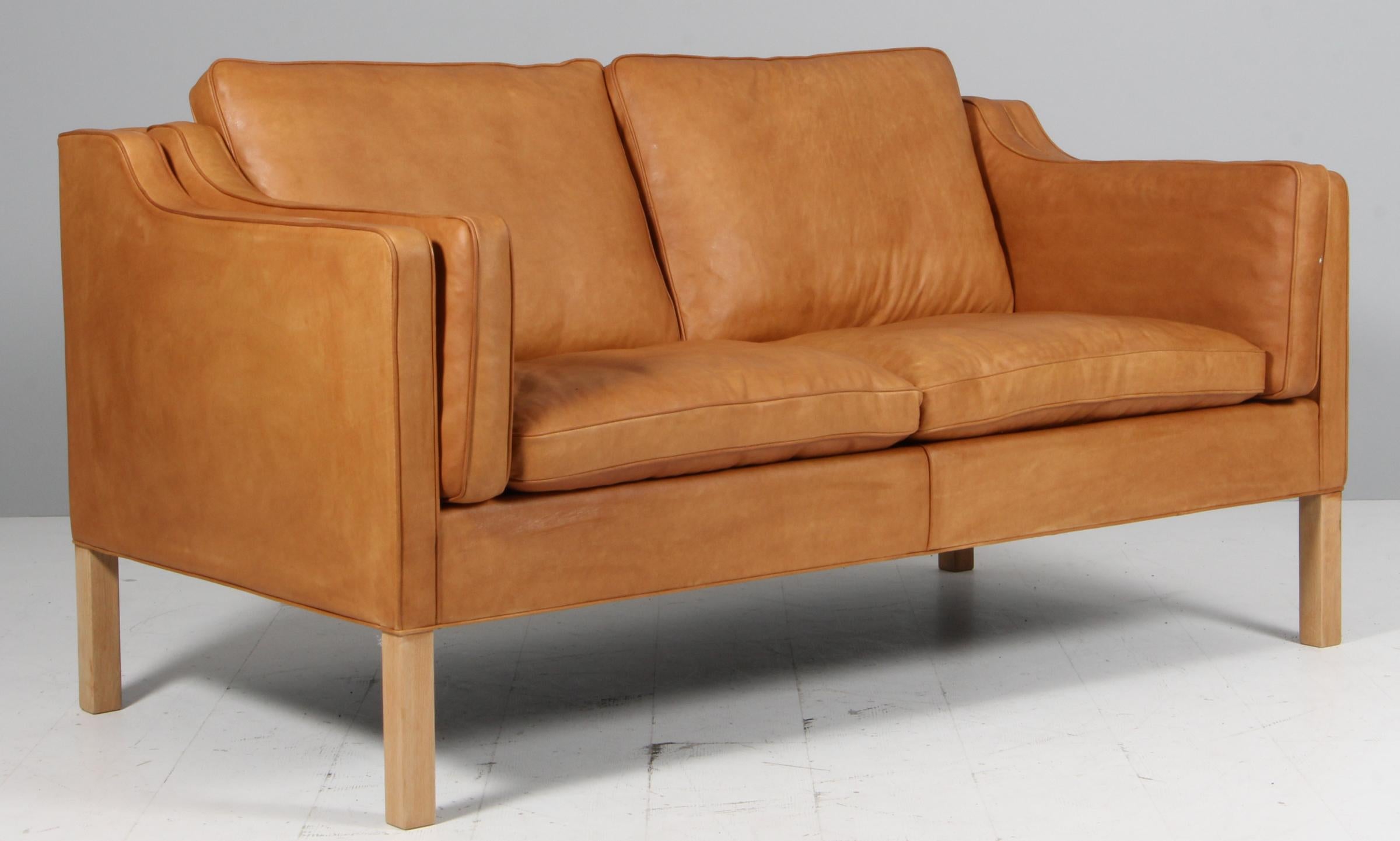 Børge Mogensen two-seat sofa new upholstered with vintage tan full grain aniline leather.

Legs of oak.

Model 2212, made by Fredericia Furniture.