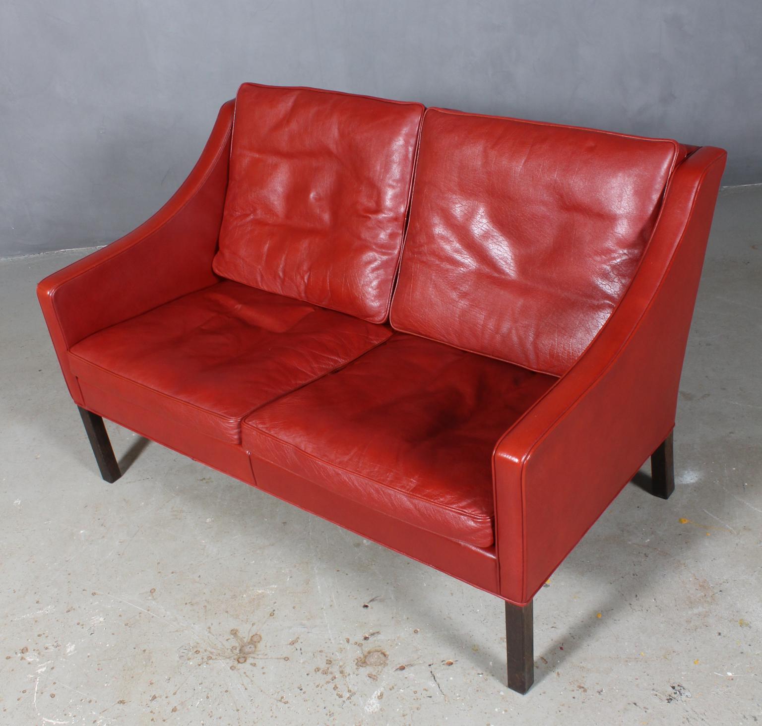 Børge Mogensen two-seat sofa original upholstered with red leather upholstery.

Legs of smoked oak.

Model 2208, made by Fredericia furniture.