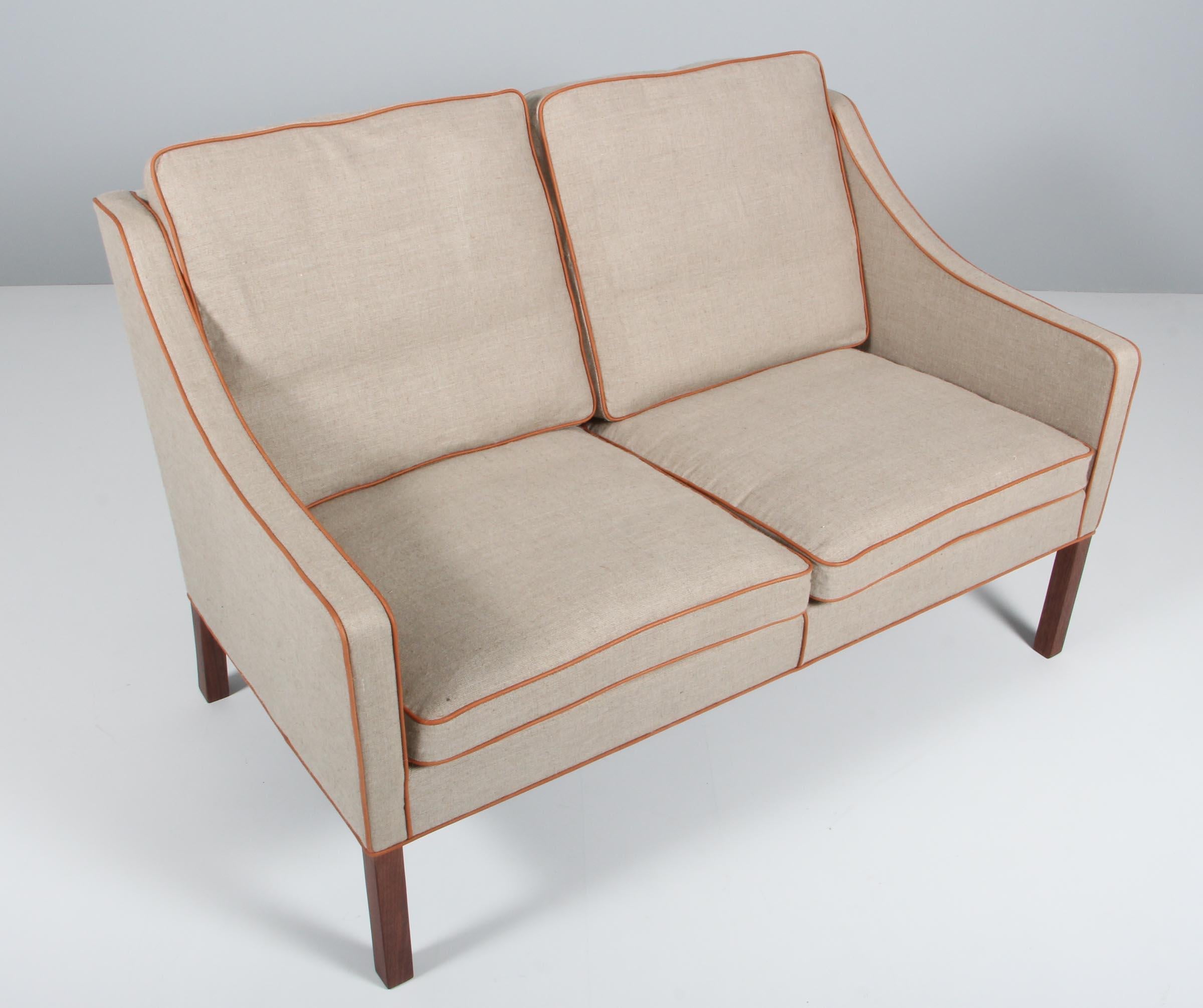 Børge Mogensen two-seat sofa new upholstered with canvas and tan aniline leather.

Legs of mahogany.

Model 2209, made by Fredericia furniture.