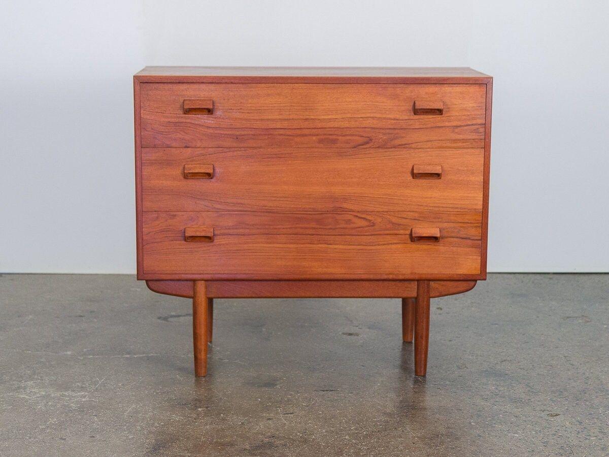 Classic teak vanity within a dresser, designed by Børge Mogensen for Soborg. The top drawer features additional shelving and storage to include a fold out mirror. The wood is bright and clean and is in good, vintage condition. Stately and practical,