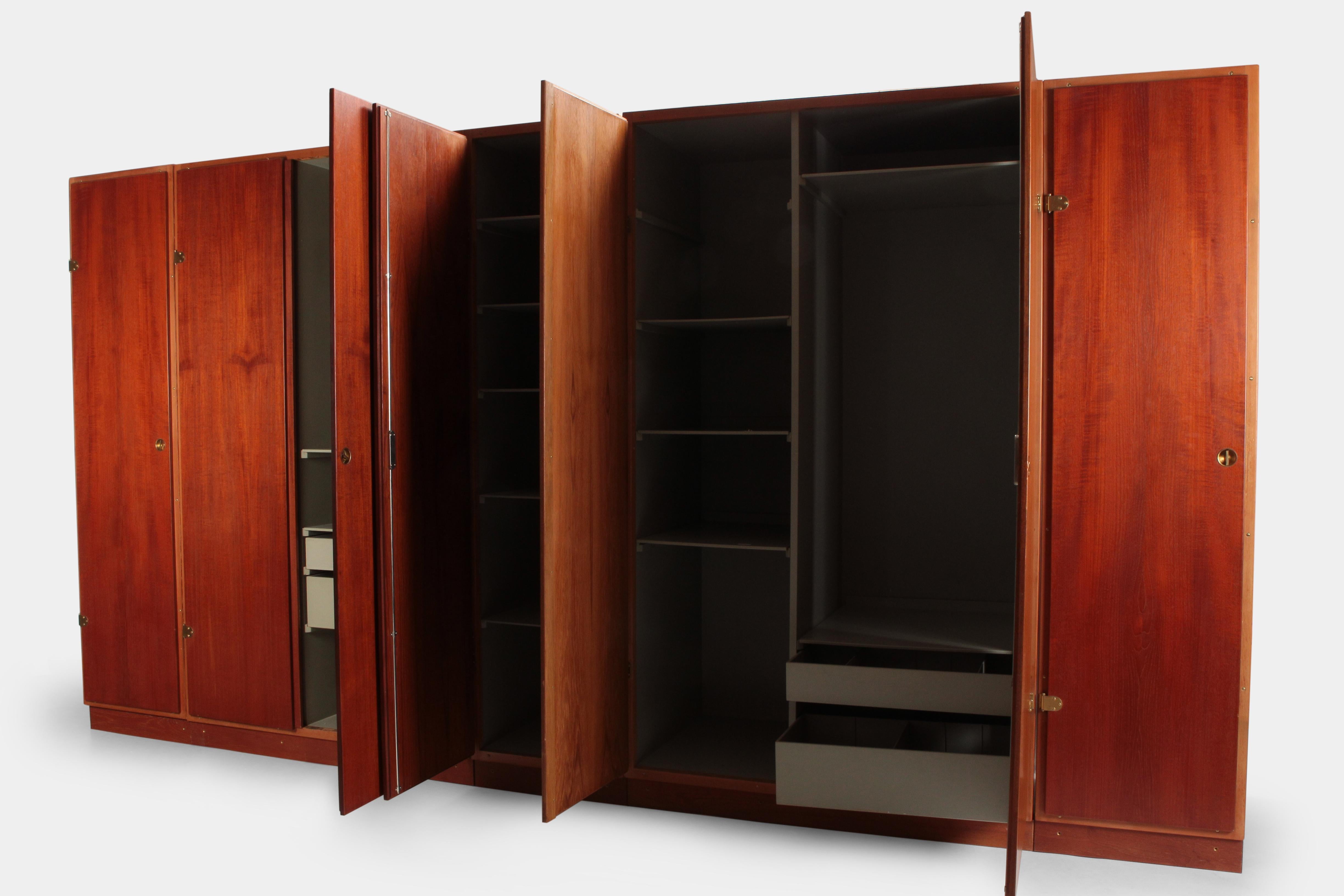 Børge Mogensen wardrobe manufactured by Karl Andersson & Söner in the 1960s in Denmark. Very generous wardrobe with several shelves, drawers and hanging mounts. The fronts are veneered with teak wood and have details made of solid brass. The inside