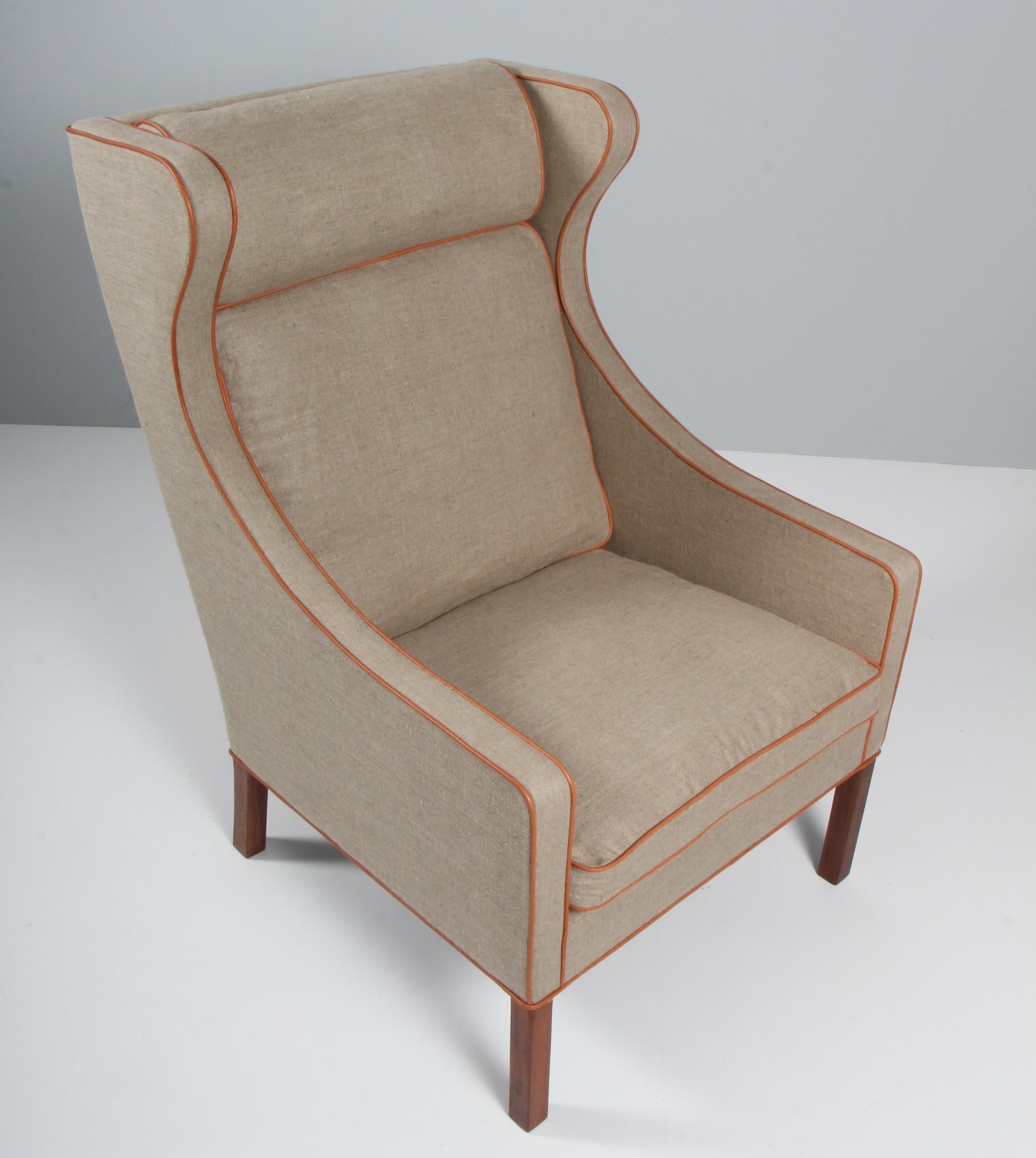 Børge Mogensen wingback chair new upholstered with canvas and cognac aniline tubings.

Legs in teak.

Model 2204, made by Fredericia Furniture.
