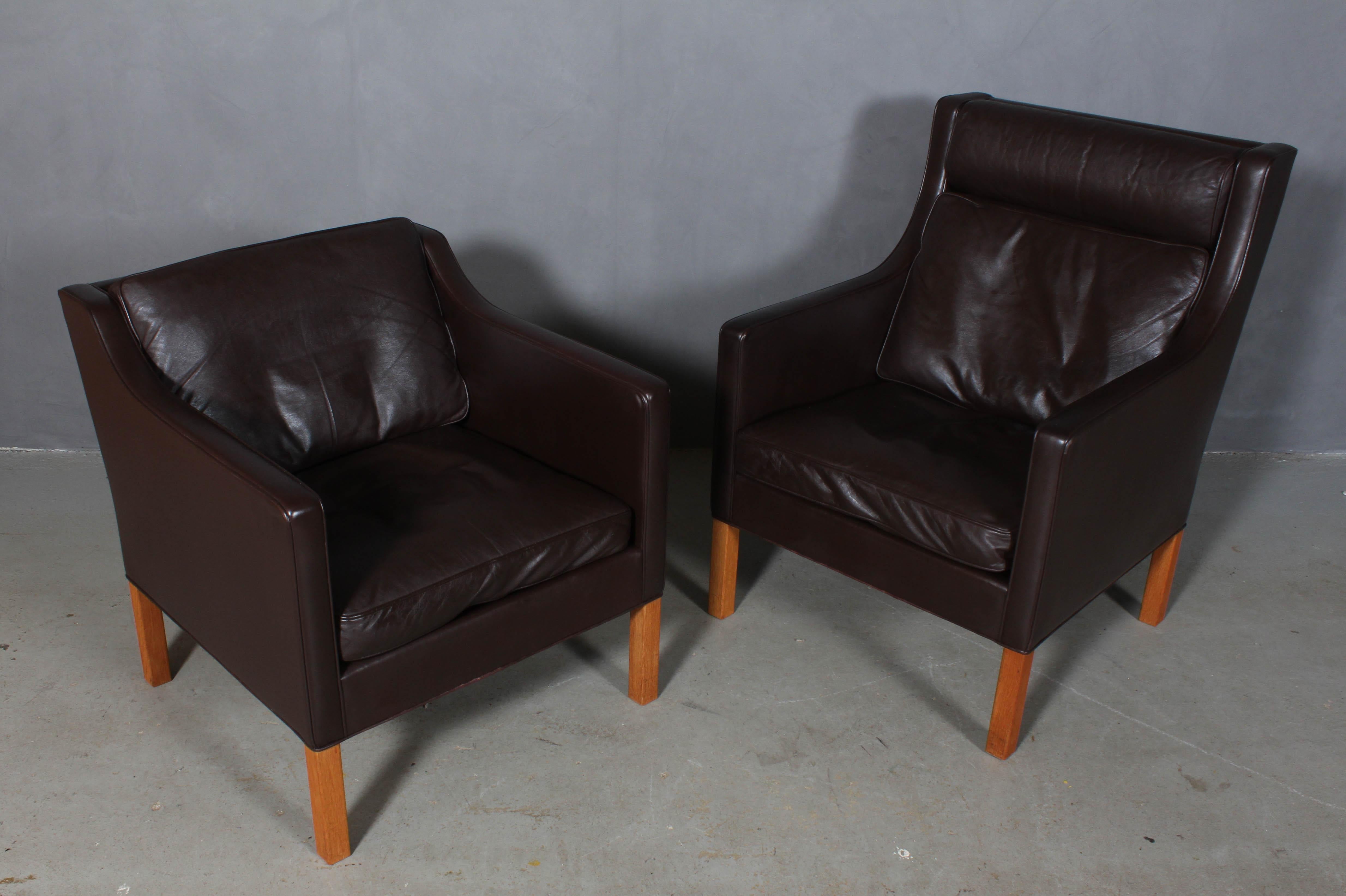 Børge & Peter Mogensen set of lounge chairs in original brown leather upholstery. 

Legs in oak.

Model 2431 and 2421, made by Fredericia furniture.

This is a cooperation between Børge Mogensen and his son Peter Mogensen.