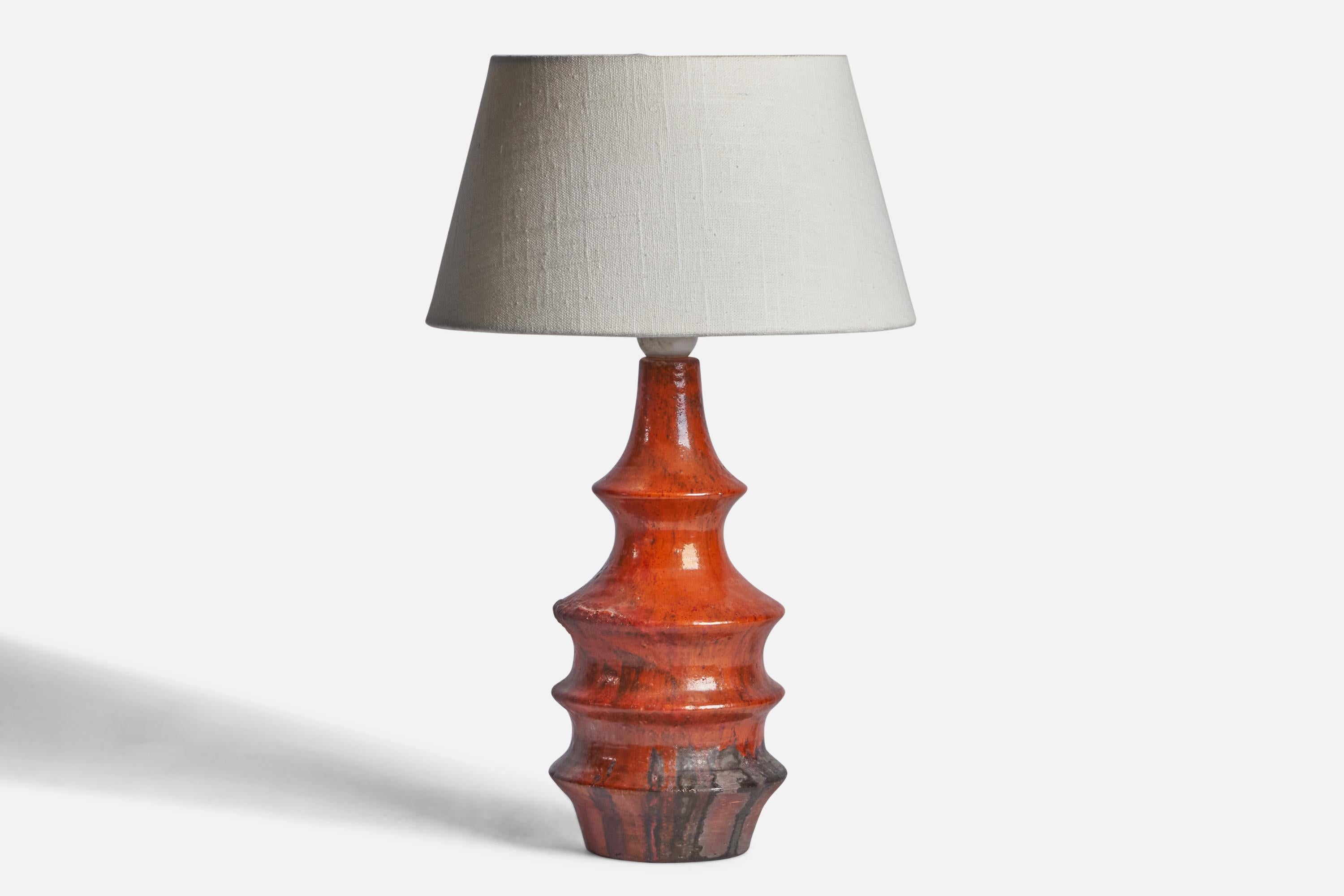 A red and black-glazed stoneware table lamp designed by Architect Børge Wernonch and produced by Afta, Denmark, c. 1940s.

Dimensions of Lamp (inches): 13.25” H x 4.75” Diameter
Dimensions of Shade (inches): 7” Top Diameter x 10” Bottom Diameter x