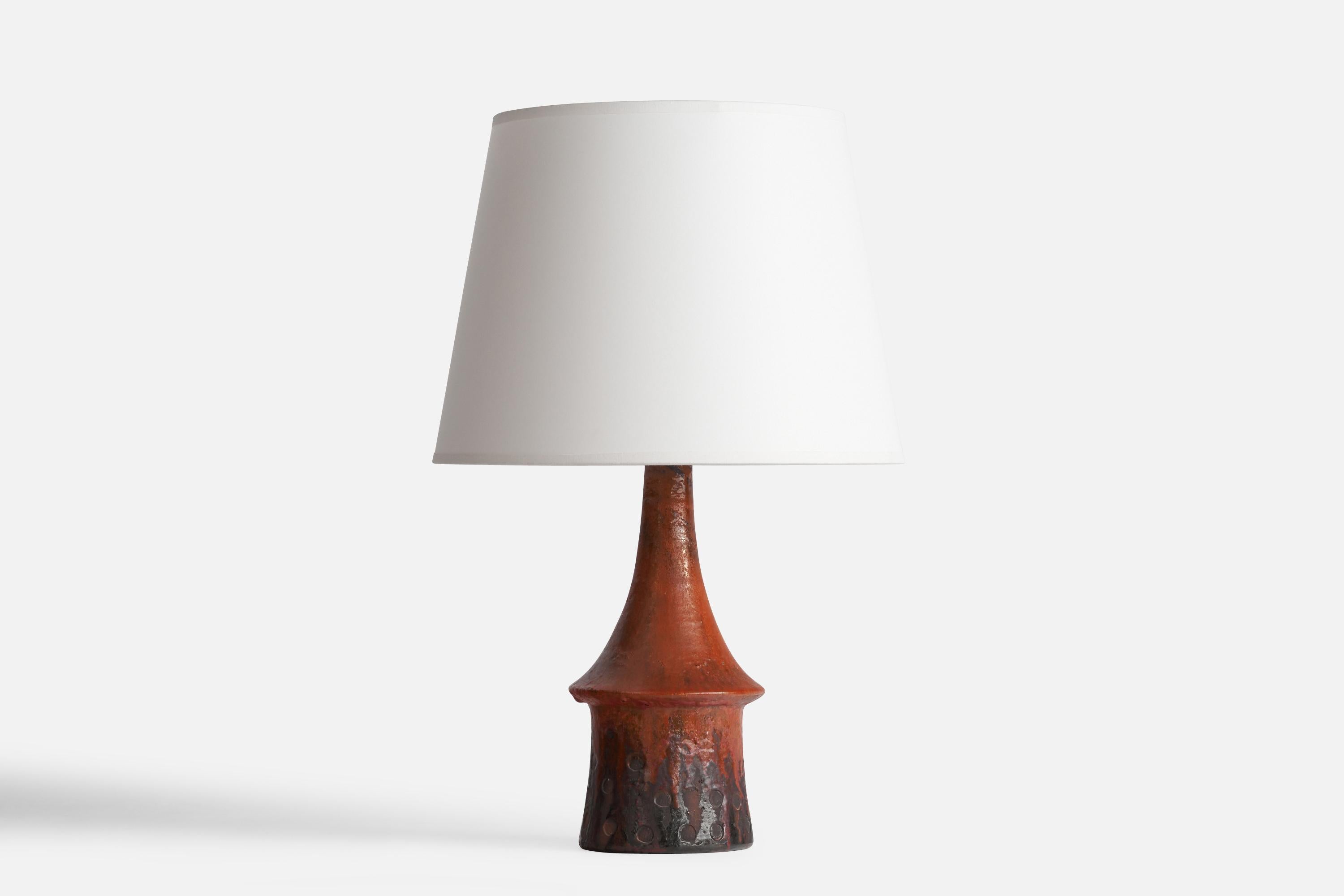 A red-glazed stoneware table lamp designed by Architect Børge Wernonch for Afta, Denmark, c. 1940s.

Dimensions of Lamp (inches): 13” H x 5”  Diameter
Dimensions of Shade (inches): 9” Top Diameter x 12” Bottom Diameter x 9” H
kDimensions of Lamp