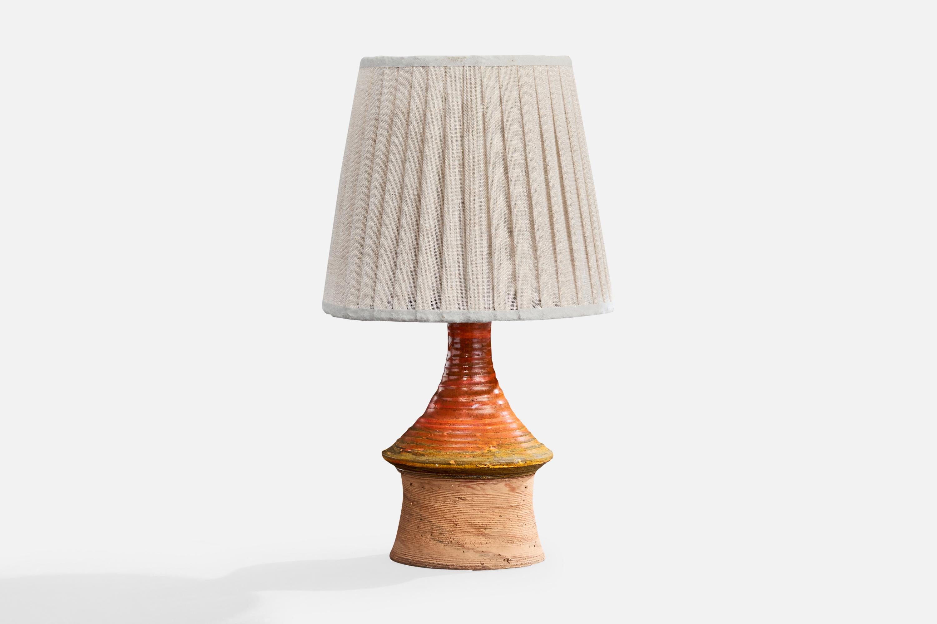 A red, yellow-glazed stoneware and white fabric table lamp designed by Architect Børge Wernonch for Afta, Denmark, c. 1940s.

Dimensions of Lamp with Shade (inches): 12.25