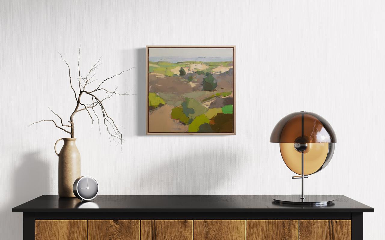 This small original abstracted landscape oil painting by artist Bri Custer features an earth-toned palette with shades of green, beige and umber throughout the foreground under a pale blue sky. The artist applies thick layers of paint in large