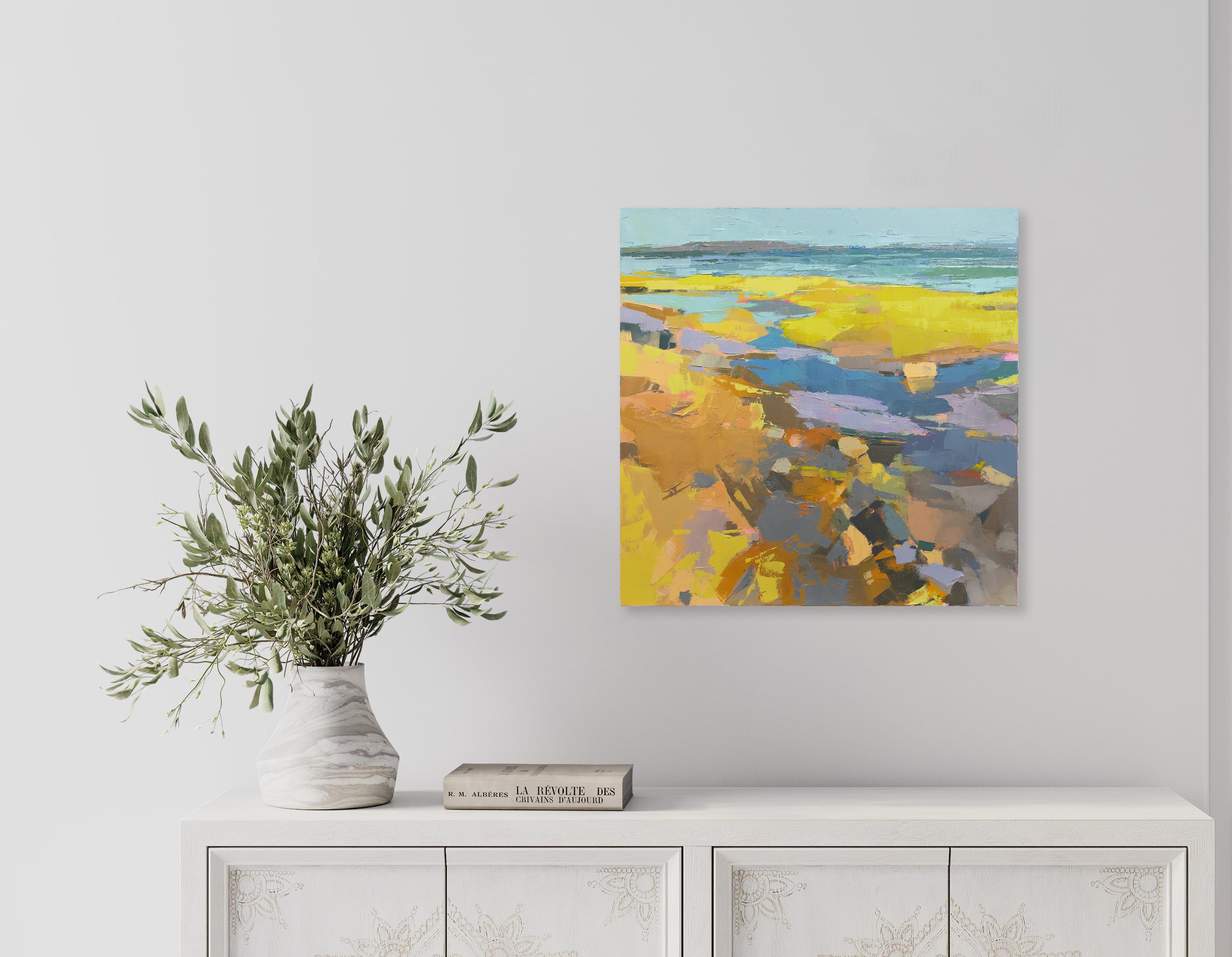 This original abstracted coastal landscape oil painting by artist Bri Custer features a vibrant blue and yellow palette. It captures an abstracted view of a shoreline, with thick layers of paint, loosely applied on the surface of the canvas. The