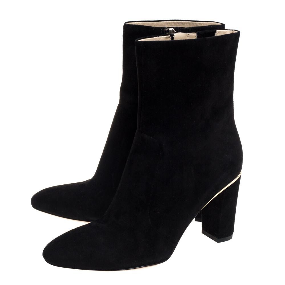 Brian Atwood elevates your style quotient giving you just the right amount of attention with this gorgeous pair of black boots. These luxurious suede boots make for comfortable wear. They are styled with almond toes, side zippers, and gold-tone