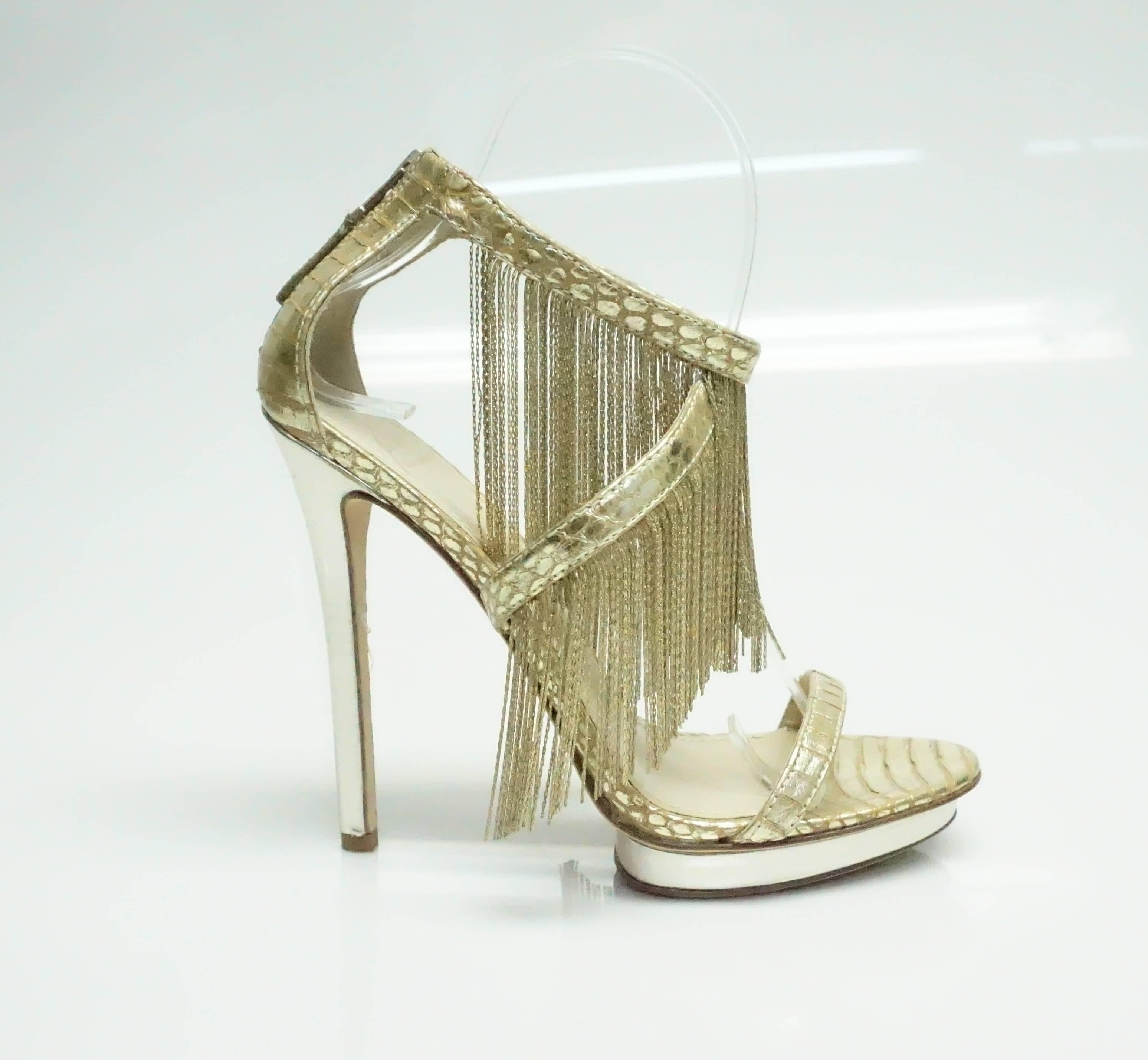 Brian Atwood Gold Metal Fringe Back Zip Sandal Heel - 7.5  These statement heels are in excellent condition. They have a thin gold strop across the foot and form a crisscross across the top of the foot securing with an ankle strap and a back zipper.