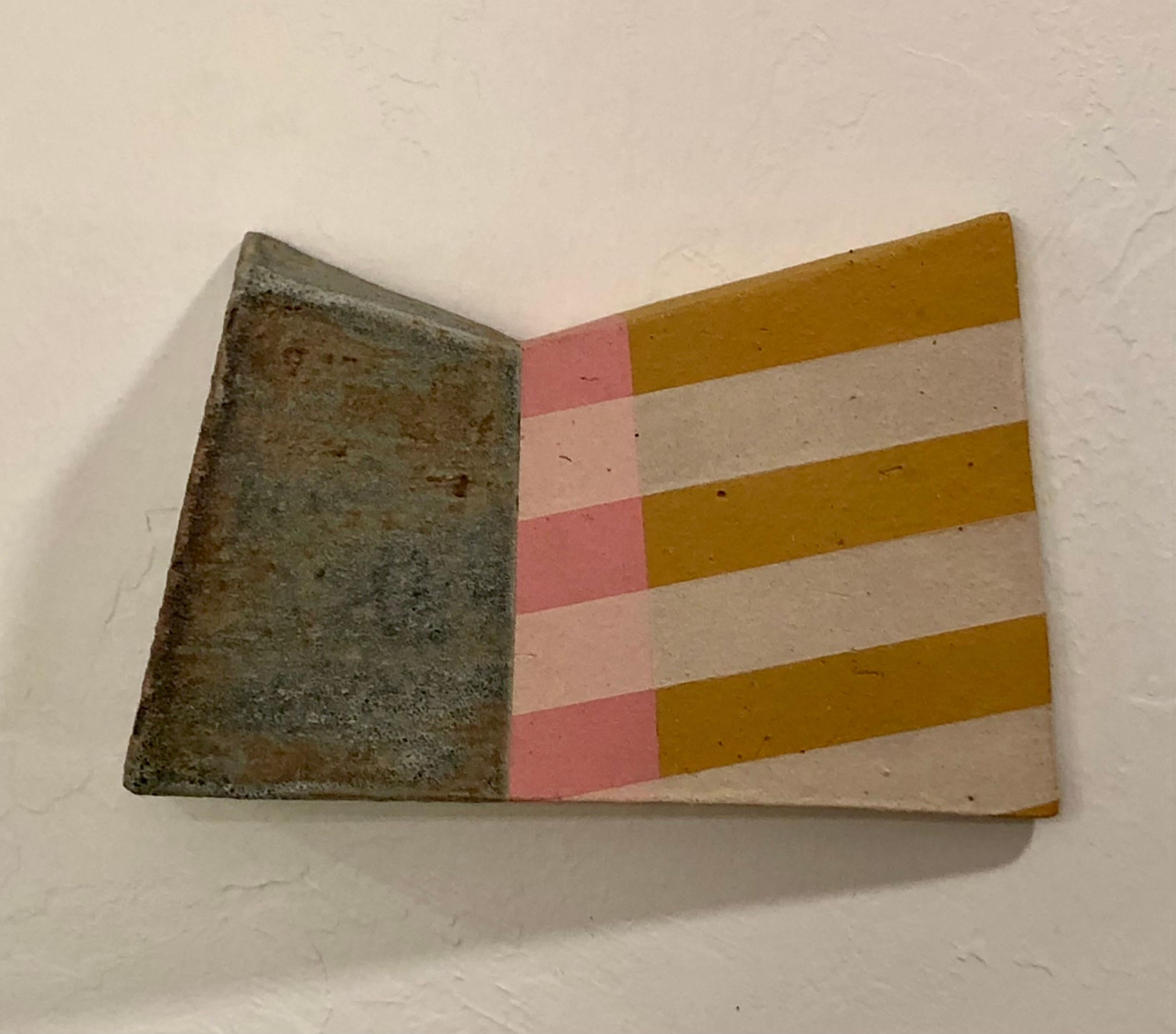 This 5.5" x 8.5" ceramic wall sculpture was created by Brian Bosworth. This is a contemporary piece that demonstrates sophisticated glazing techniques and compositional balance. The work is constructed as a single angular form, roughly