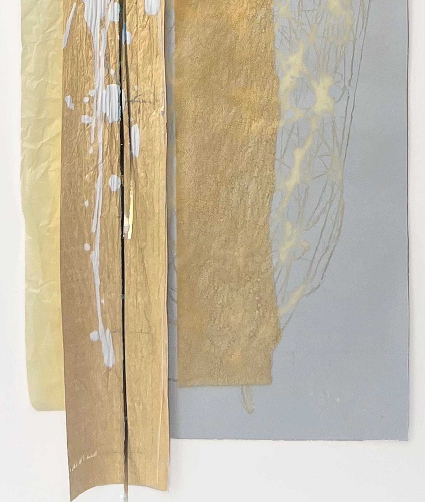 This is a large-scale vertical layered collage with gold, silver, and white mixed papers and acrylic paint. It is professionally framed in a narrow, contemporary brushed nickel finish metal frame. These work well in a series (see photo gallery for