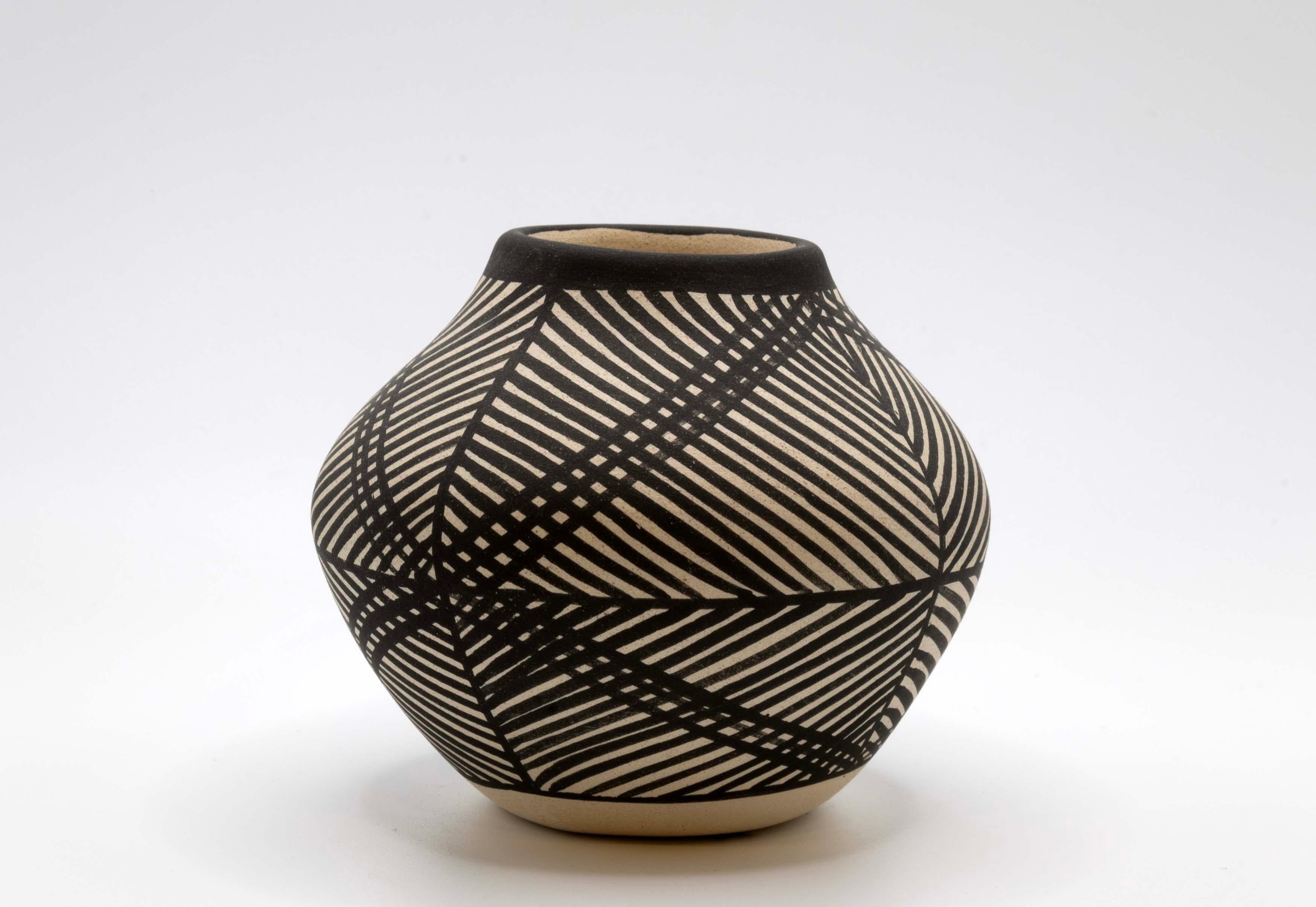 A unique set of 3 Acoma Pueblo pottery from New Mexico. Each vessel is marked with “Acoma” with a different artist’s signature: B. DeLorme (Brian DeLorme), V.V. and C.S. The vessels are fired earthenware with highly stylized geometric designs in