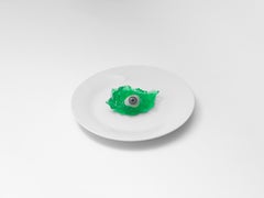 Prosthetic Glass Blue Eye in Green Jelly on White Plate by Brian Griffin