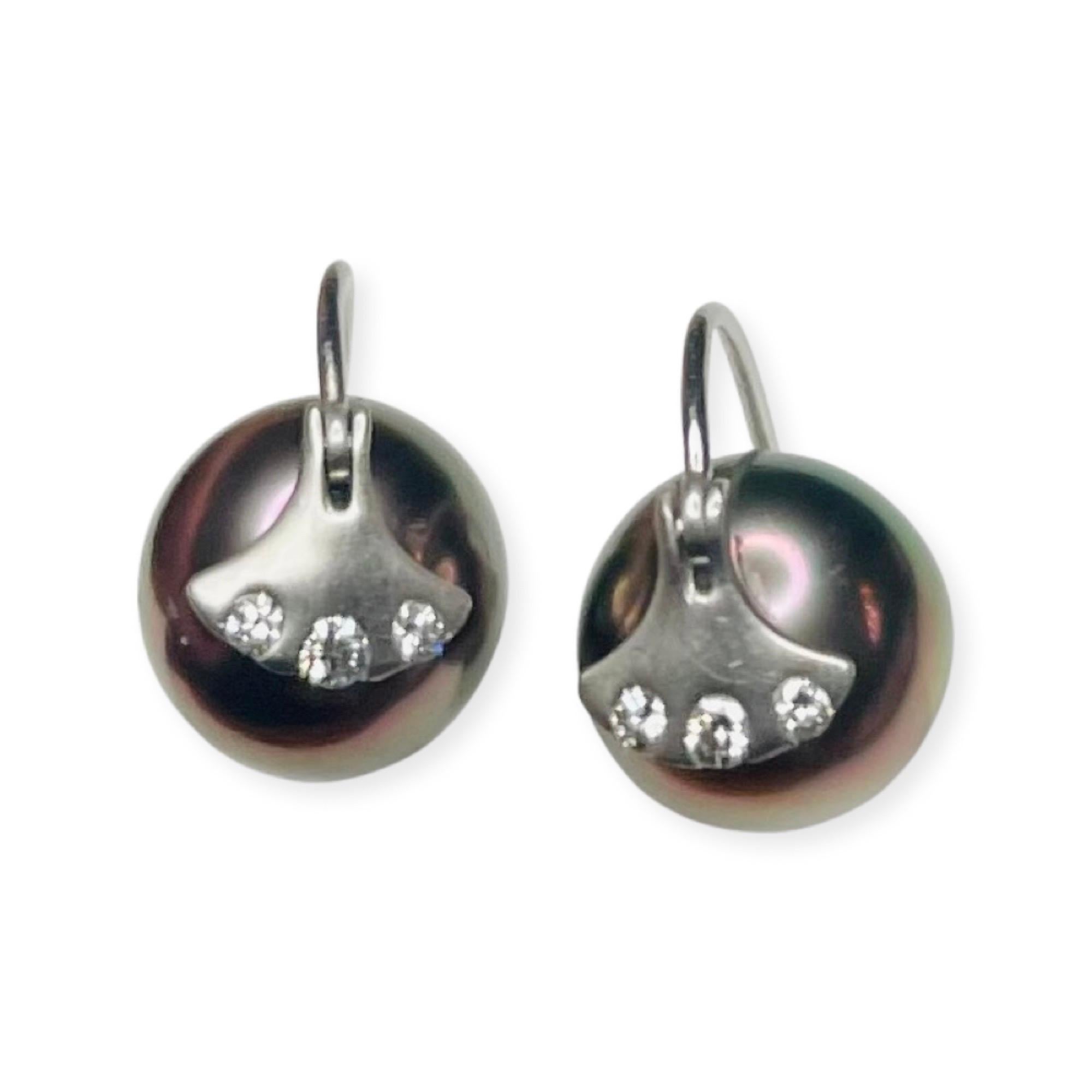 Brian Sholdt Platinum, Natural Color, Cultured. Black Tahitian Pearl Earrings. The Pearls measure 10.5 mm. They are round with slight blemishes and a rose overtone. They have a high luster.  There is a fan shaped, platinum piece at the top of the