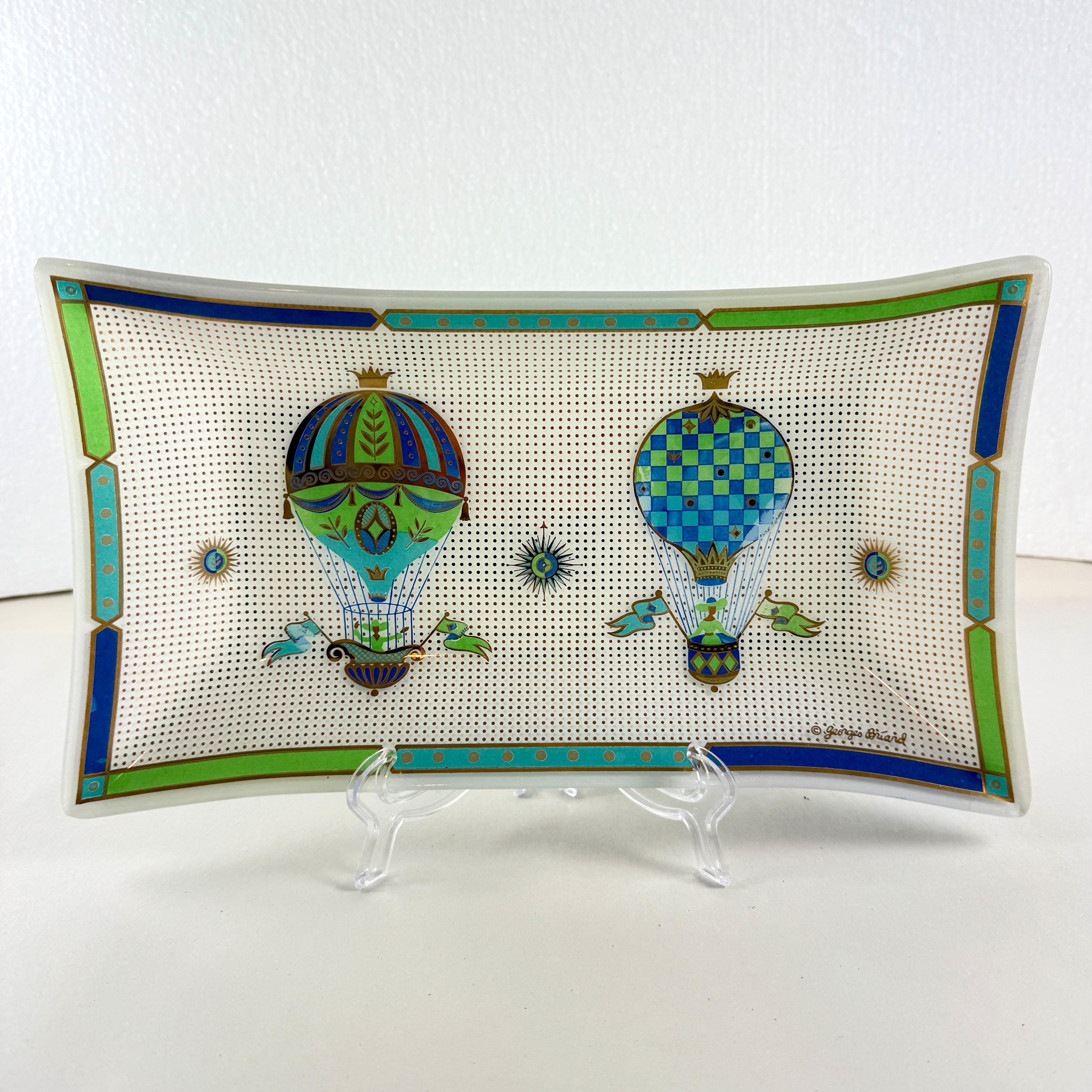 From the designer Georges Briard, and from the Fancy Free collection, a large square pebbled glass and gold leaf platter, circa 1965.

Georges Briard created his Fancy Free Balloon collection for his 1965 catalogue. The glassware serving pieces are