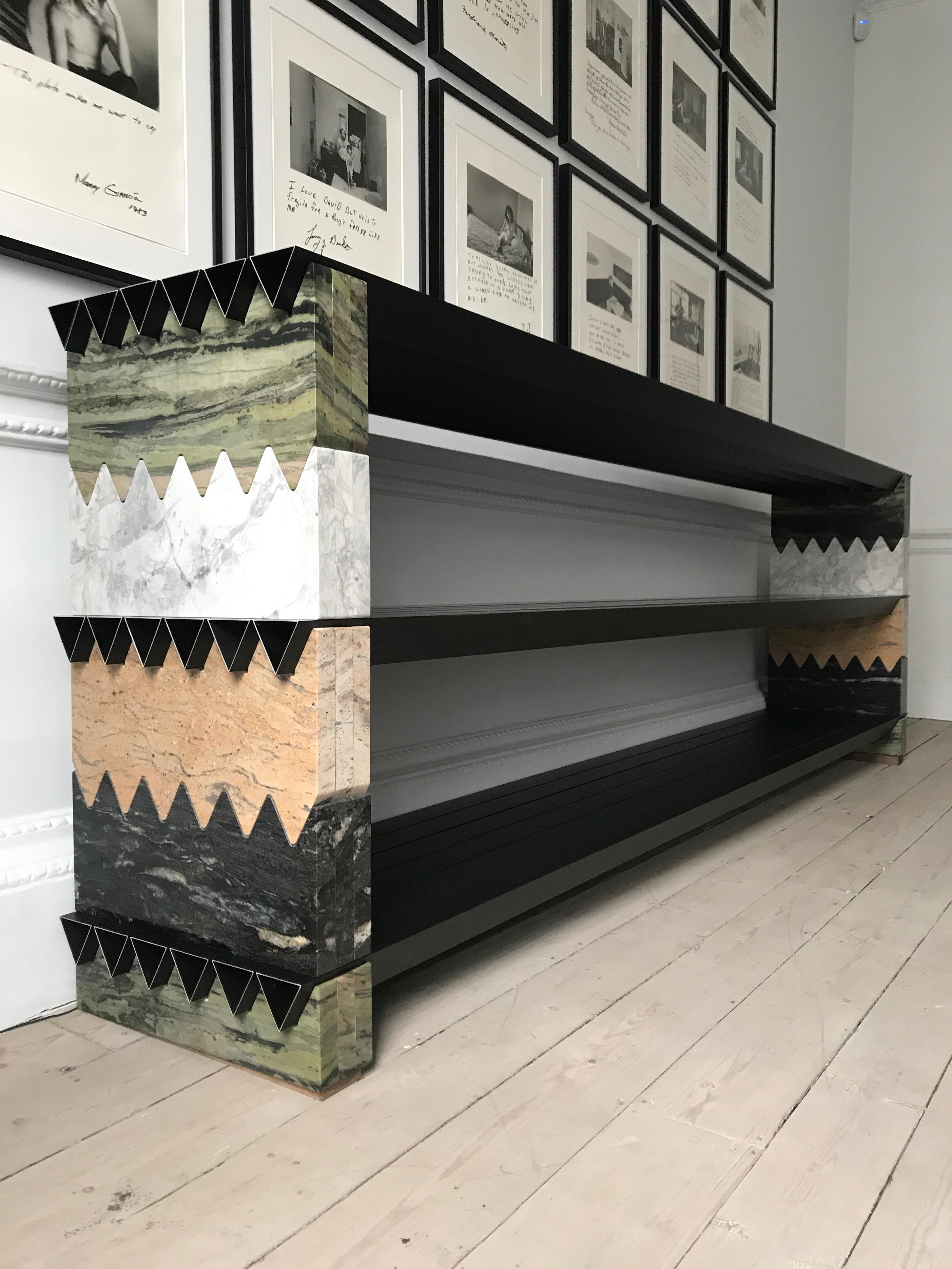 Brick and beam sideboard by Adam Blencowe
Materials: Granite, anodised aluminium
Dimensions: 300 x 80 x 50 cm

A new work produced using different granite slabs cut to interlock with each other and black
anodised aluminium beams. The components
