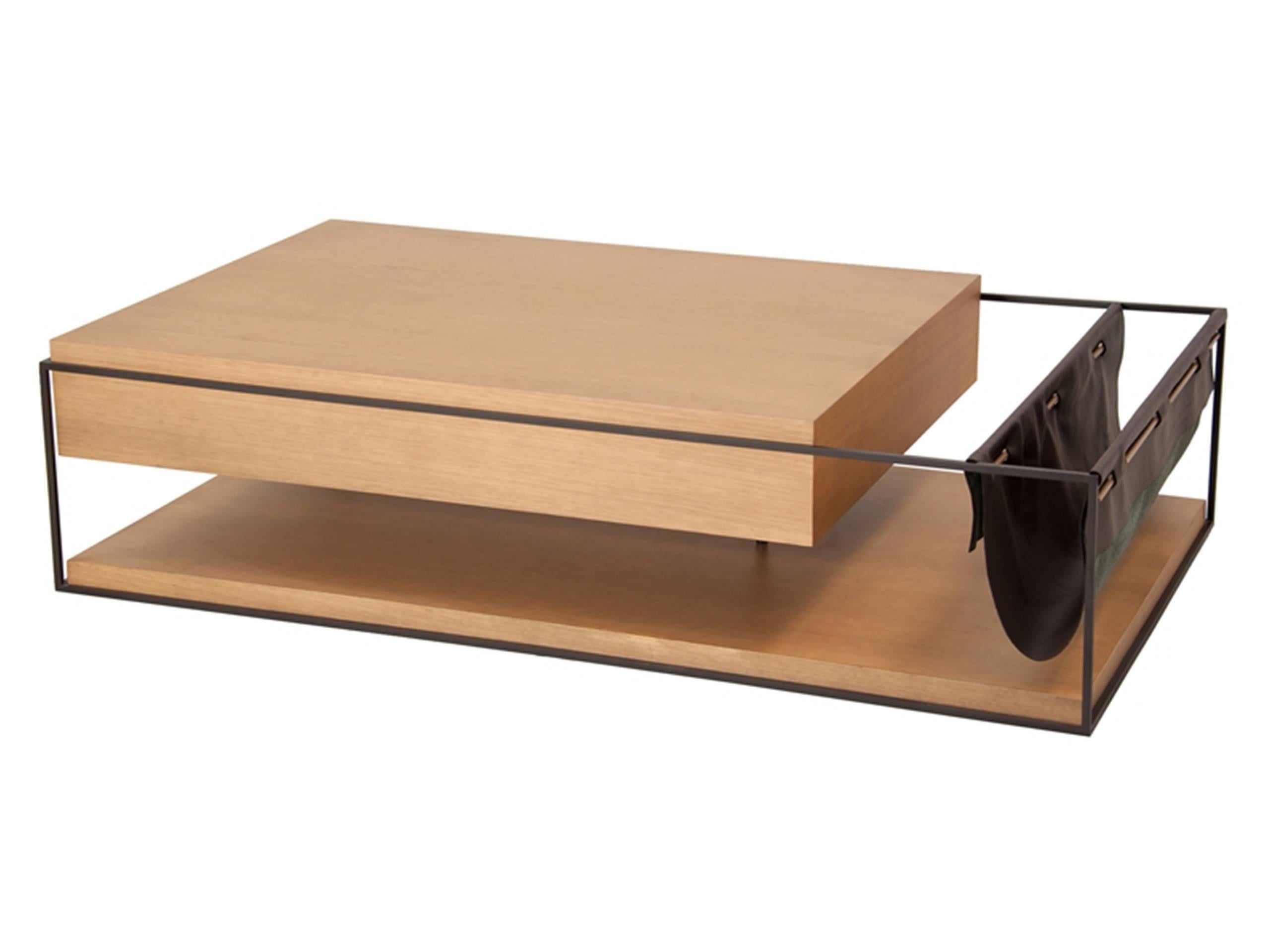 The magazine holder placed within the table structure creates a harmonious combination of different materials.