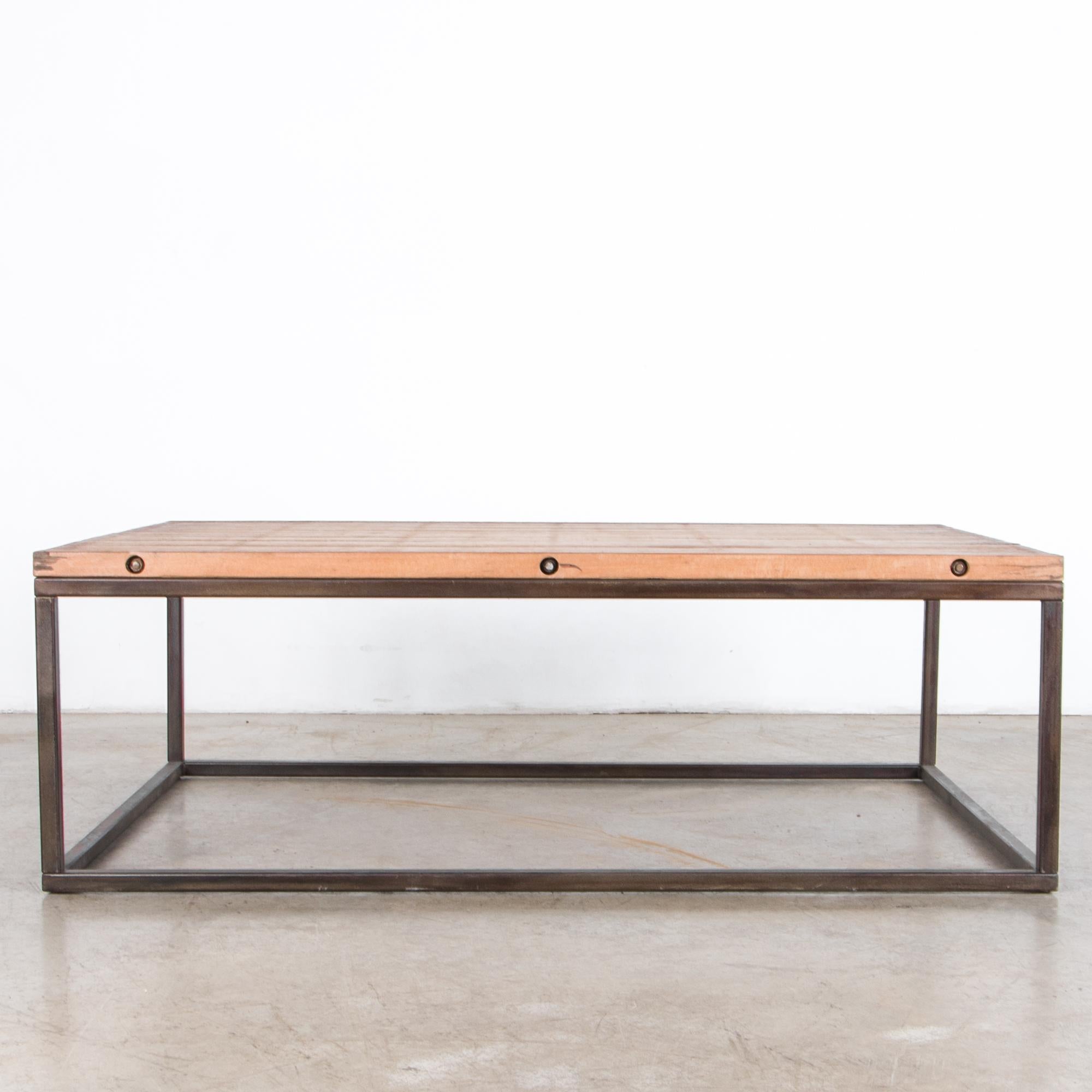 Constructed from sturdy azobé wood, reinforced with metal bars and a geometric steel base creates a minimalist suggestion of stability. Blending sleek and rustic, this 17” tall coffee table makes a comfortable and stylish place to rest your drink.