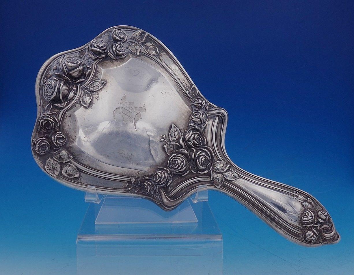 Beautiful Bridal Rose by Alvin (hallmarked for Simons, who became Alvin) rose motif sterling silver 11-piece sterling handle dresser set. This set includes:

1 - Mirror, 10 1/2