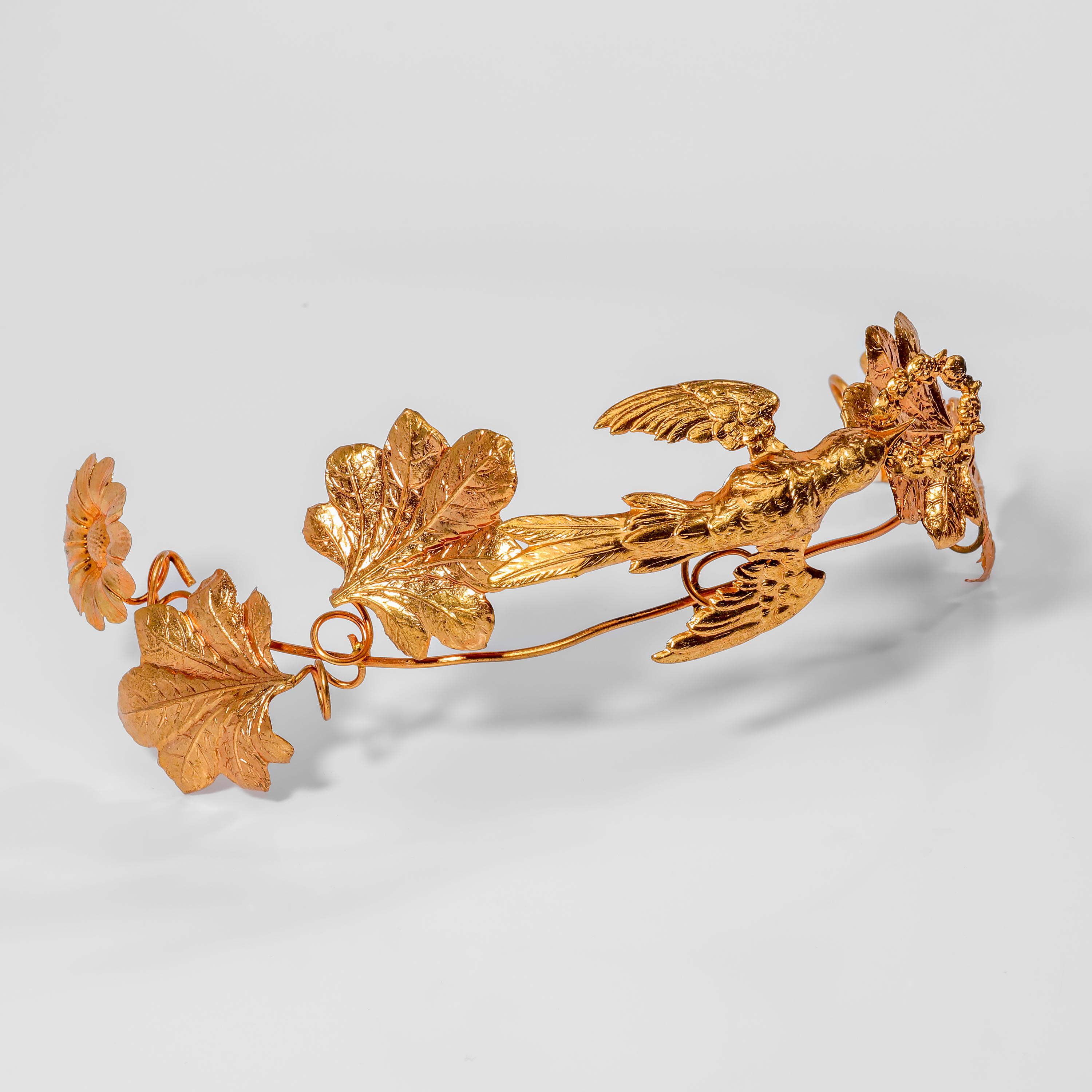 A rare and magnificent Art Nouveau tiara made from flexible golden-colored metal. Created at some point between 1910-1920, this bridal tiara is a celebration of nature in more ways than one. Flowers, leaves, and winding stems create the sides; the