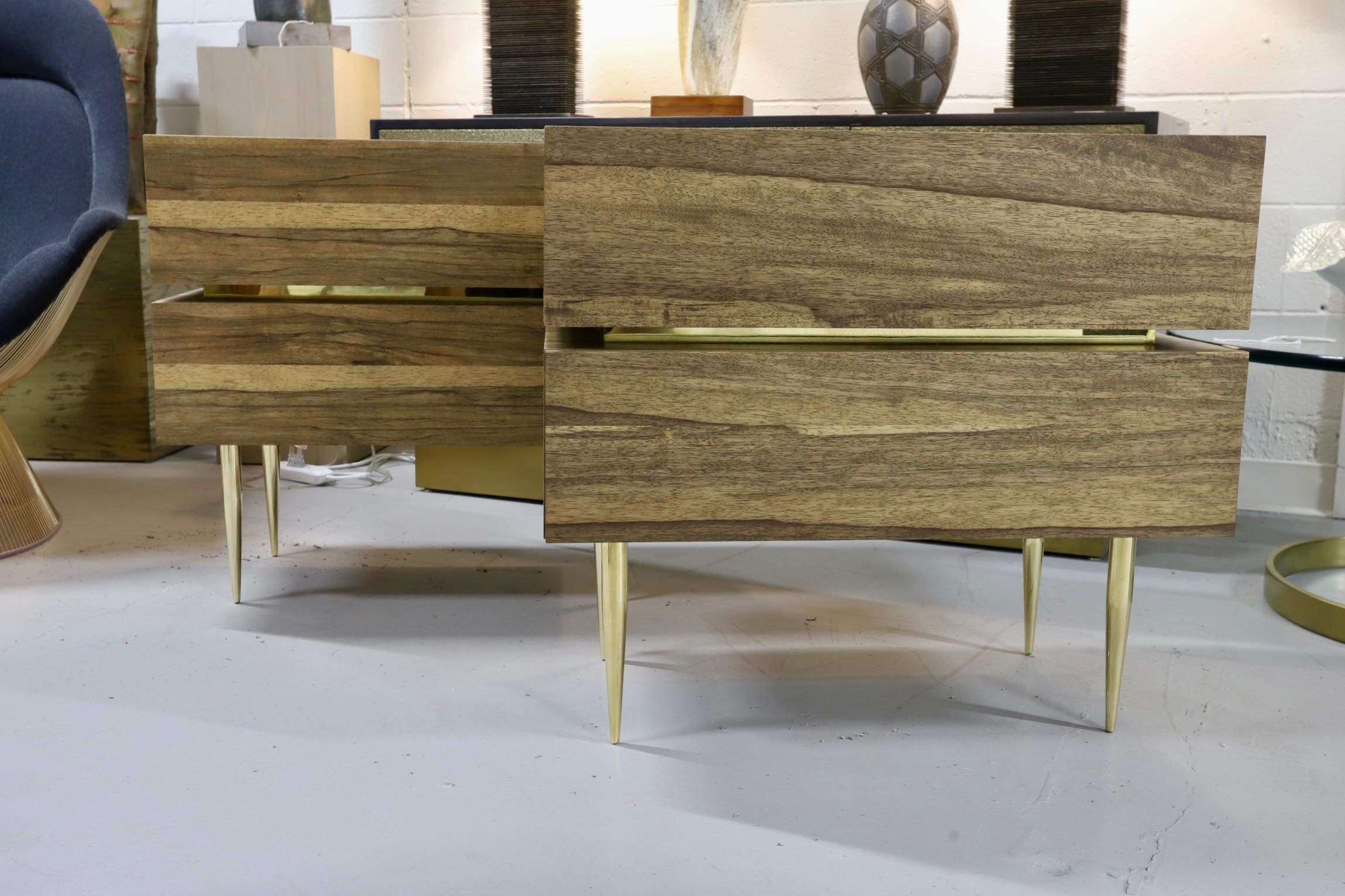 A beautiful pair of custom nightstands handcrafted out of exotic black Limba wood with solid brass legs. They feature brass banding and are finished in the back. These are made of solid black Limba wood with no veneers used. The drawer interiors are