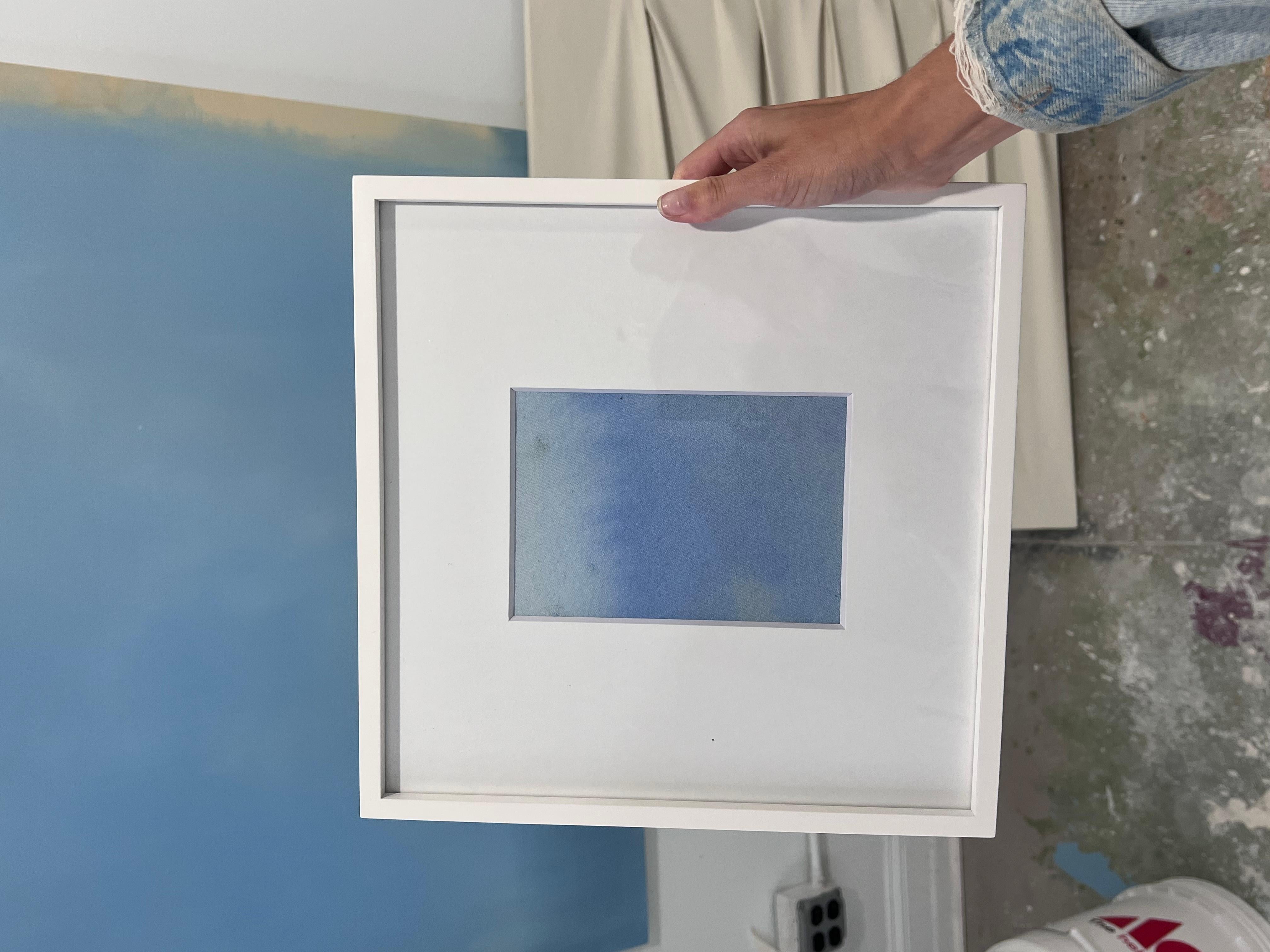 Light Blue gradient, abstract color field painting, in shadow box, white frame. 
A color field gradient abstract acrylic painting features smooth transitions of colors, often blending from one hue to another. The painting showcases a sense of depth