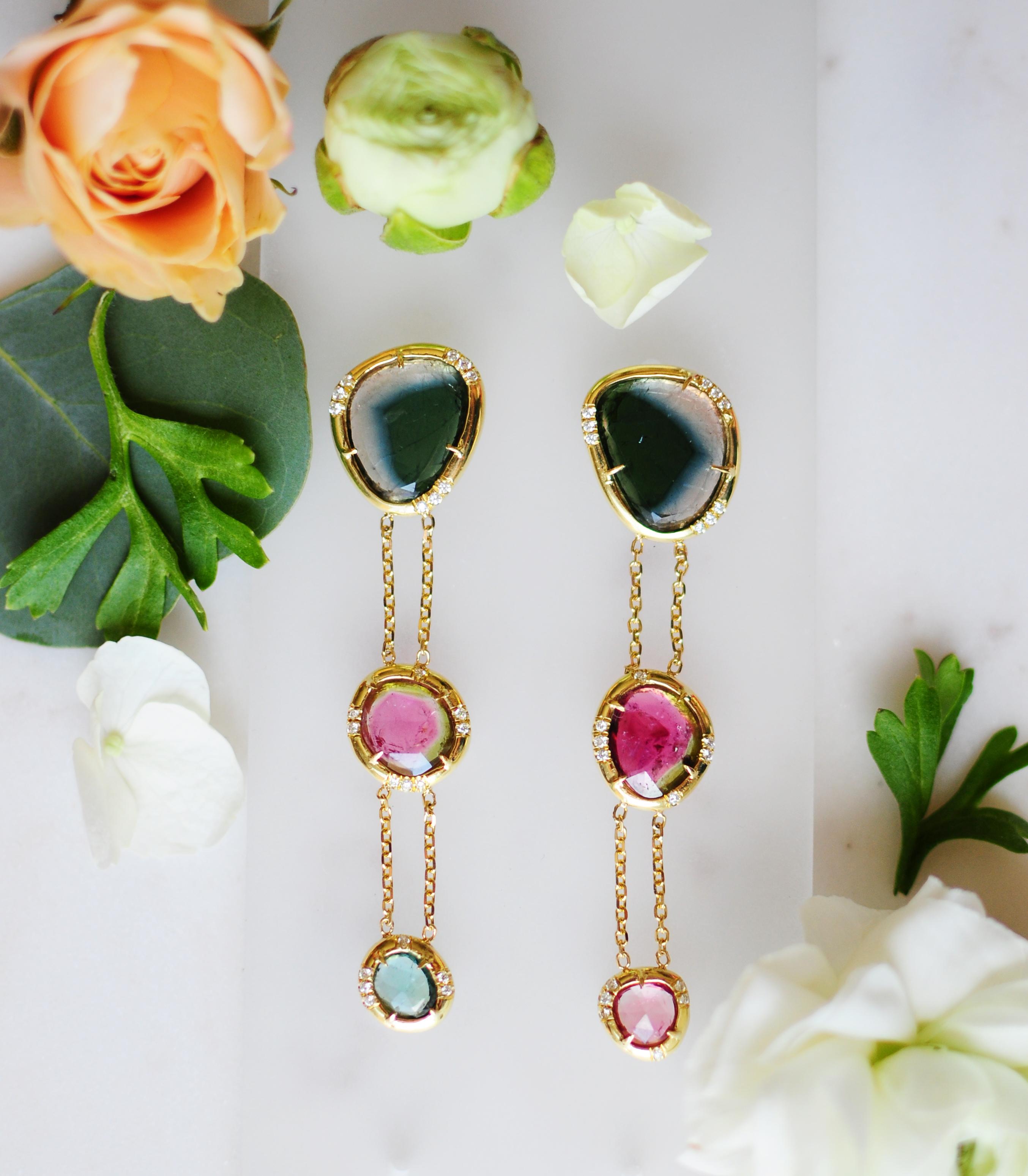 The Bridgette Earrings are striking statement pieces, handcrafted in 18kt yellow gold with an elegant 3-inch drop. Featuring unique bi-color rose-cut tourmalines paired with pavéd diamonds totaling approximately 0.45 carats, these earrings exude