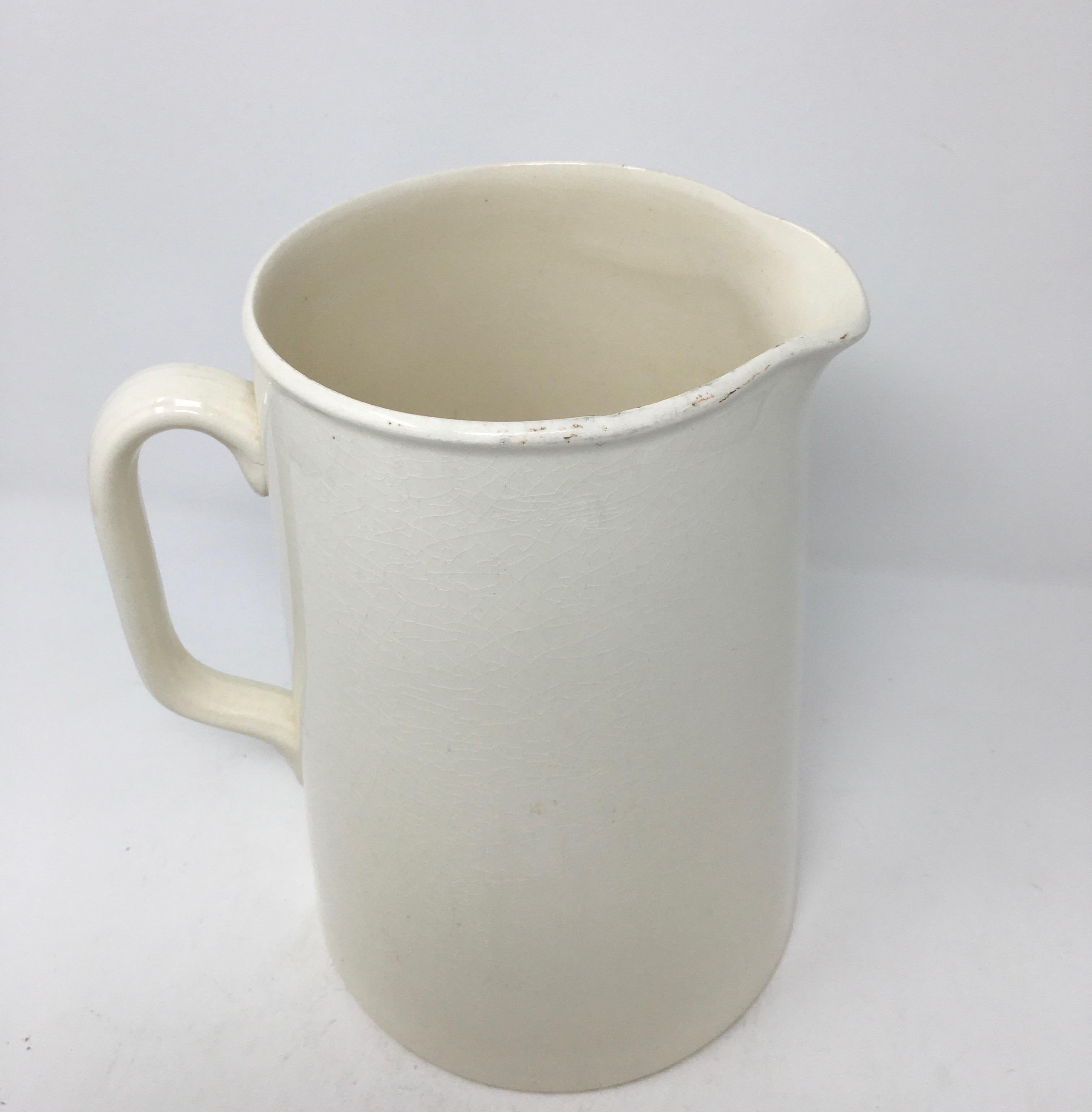 A lovely large early 20th century banded white ironstone pitcher, signed Bridgewood England on the bottom. This beautiful pitcher has simple clean lines, perfect for any decor. It would be a wonderful addition to a collection and look gorgeous