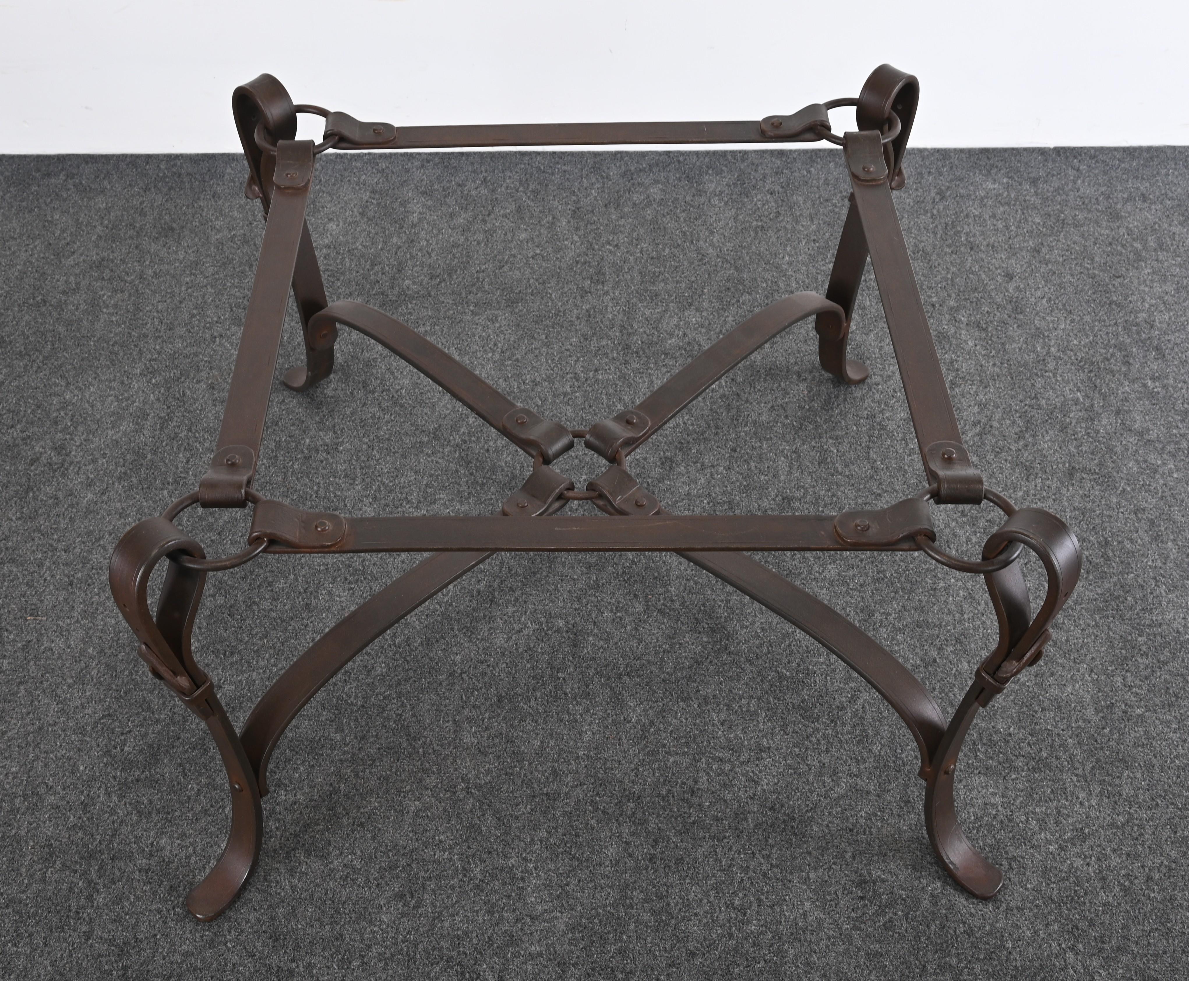 Hand-wrought iron Bridle strap coffee table in the manner of Hermes. Faux leather metal finish. Glass has some minor scratches, however, not distracting. 

Dimensions: 18.5