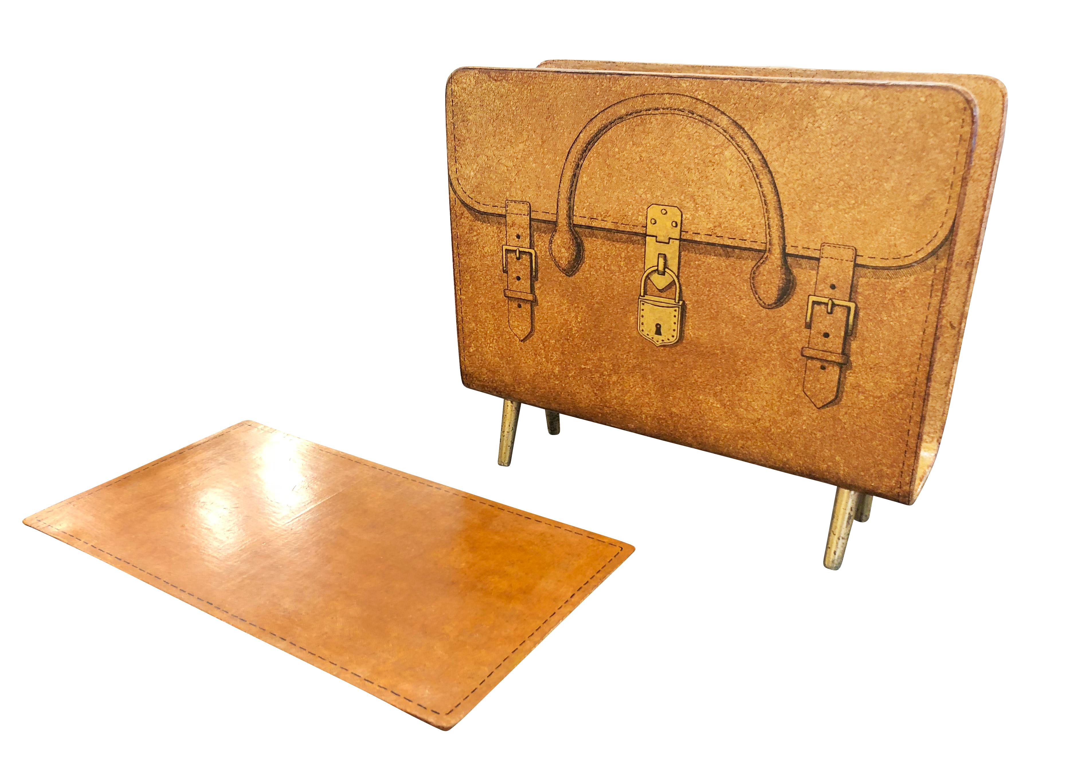 Playful magazine stand designed and manufactured by Piero Fornasetti in the 1950s. Lithographic transfer print of a leather briefcase on wood. Has brass legs and comes with a matching custom tray made by a previous owner. Cataloged.

Condition: