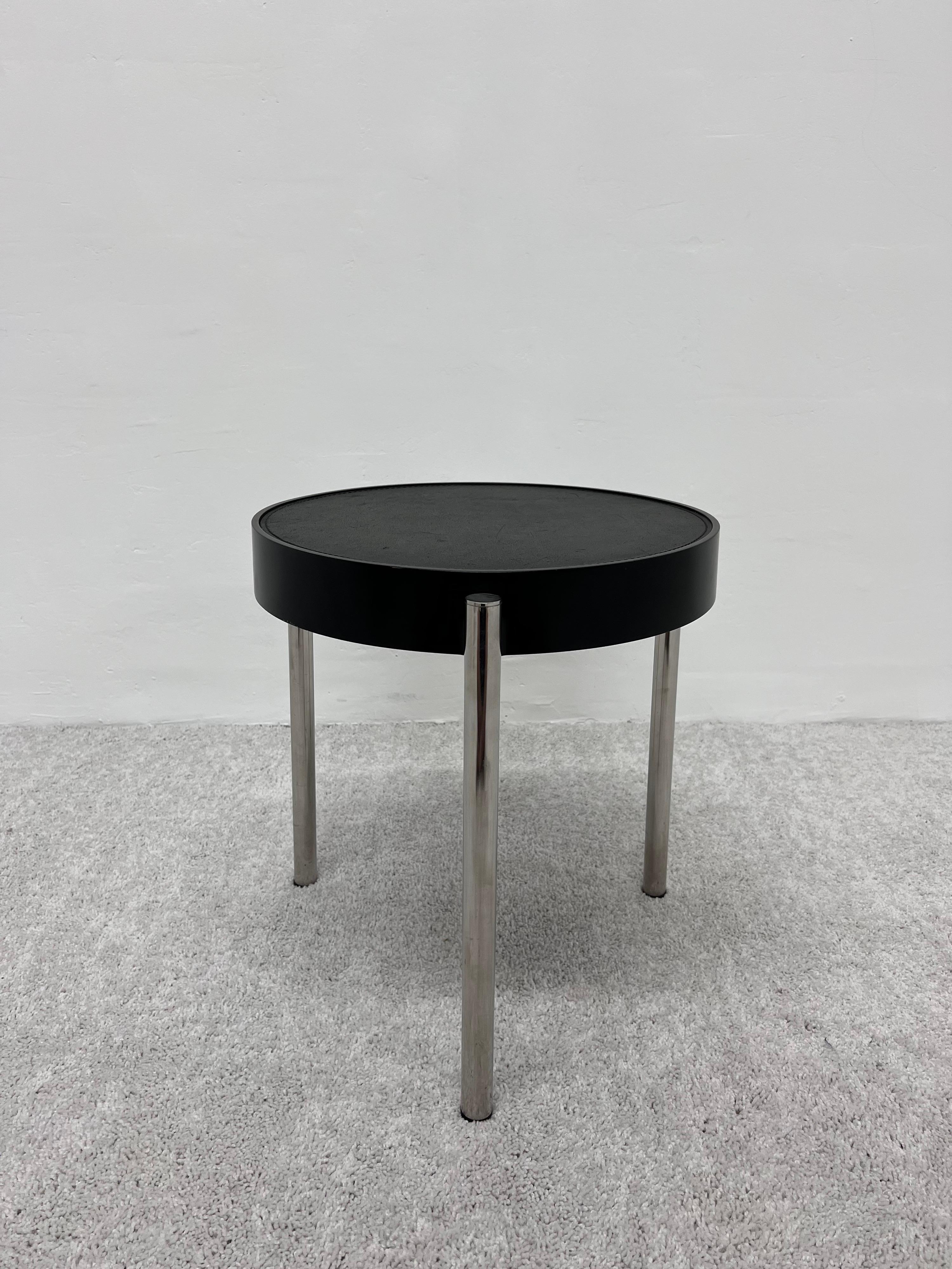 Brighella 634 side table from the Historical Archive collection of Zanotta Spa., 1980s. Top is stain resistant black leather stitched into a black lacquer hard polyurethane seat and is supported by three tubular stainless steel legs.

Top measures