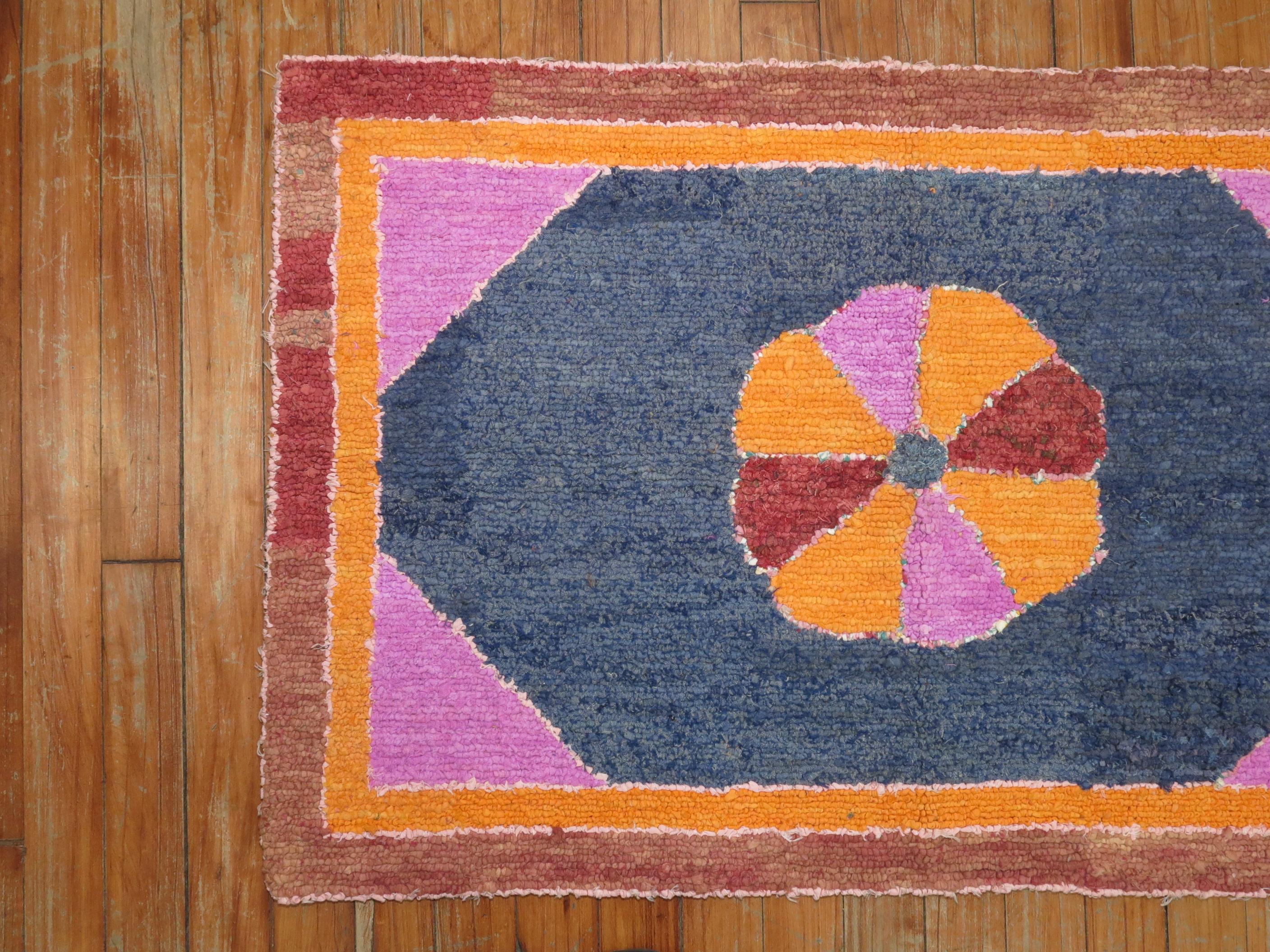 A cheerfully colored handmade decorative American hooked rug from the early part of the 20th century. Condition is really nice. No stains, no tears, has been professionally cleaned. Protective backing included.