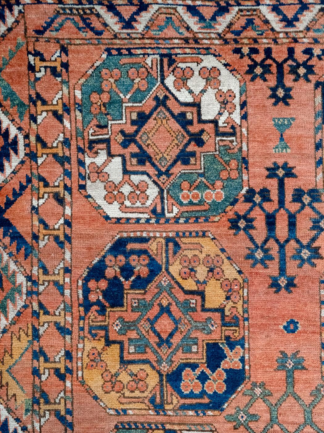 Showcasing bright and bold shades of rose, red, green, indigo, cream, orange, pink, and black wool, this Antique Persian Esari carpet measures 7’2” x 9’ and was woven in Iran circa 1880. With 18 large and colorful medallions decorated with garlands